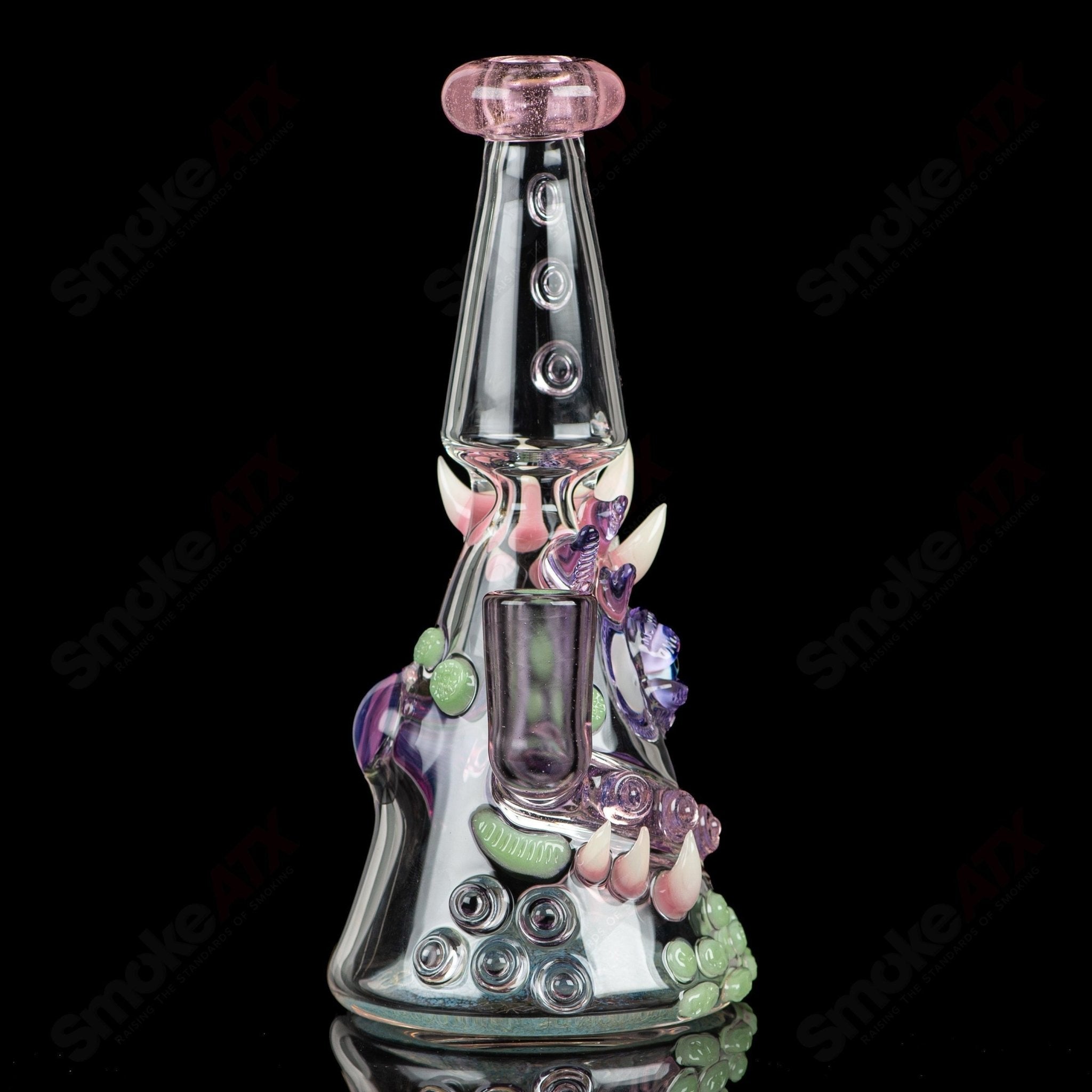 CFL Rip Curl by Helix Salt Glass, a colorful heady glass concentrate rig with intricate rip curl design and sturdy base.