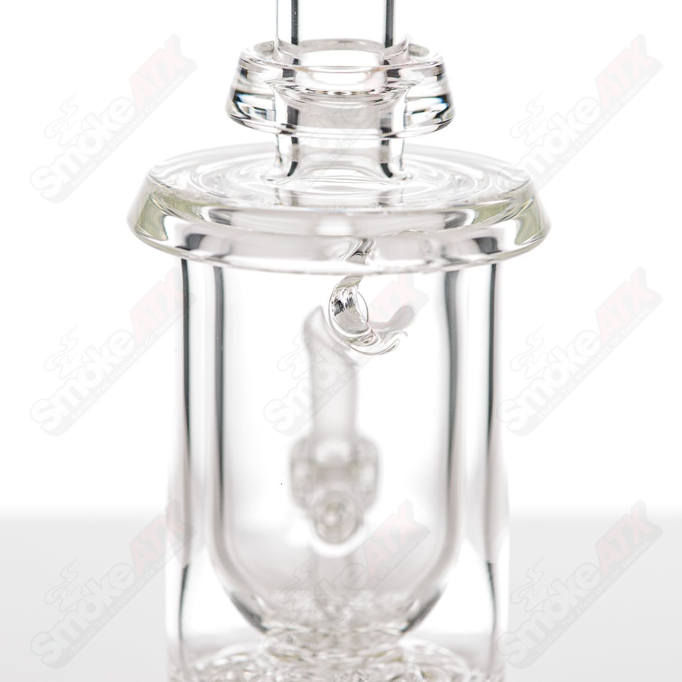 Clear Brickstack Incycler Leisure glass concentrate rig with a multi-chamber design, featuring a clear glass build and intricate details.