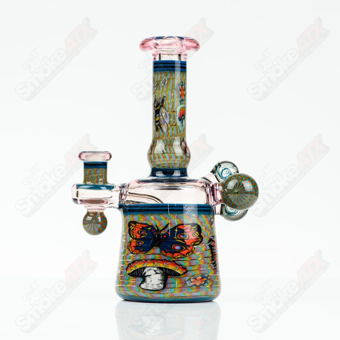 Coiled Latticello Milli Rig by Conversion Glass, a colorful heady concentrate rig with intricate glasswork and a coiled design.
