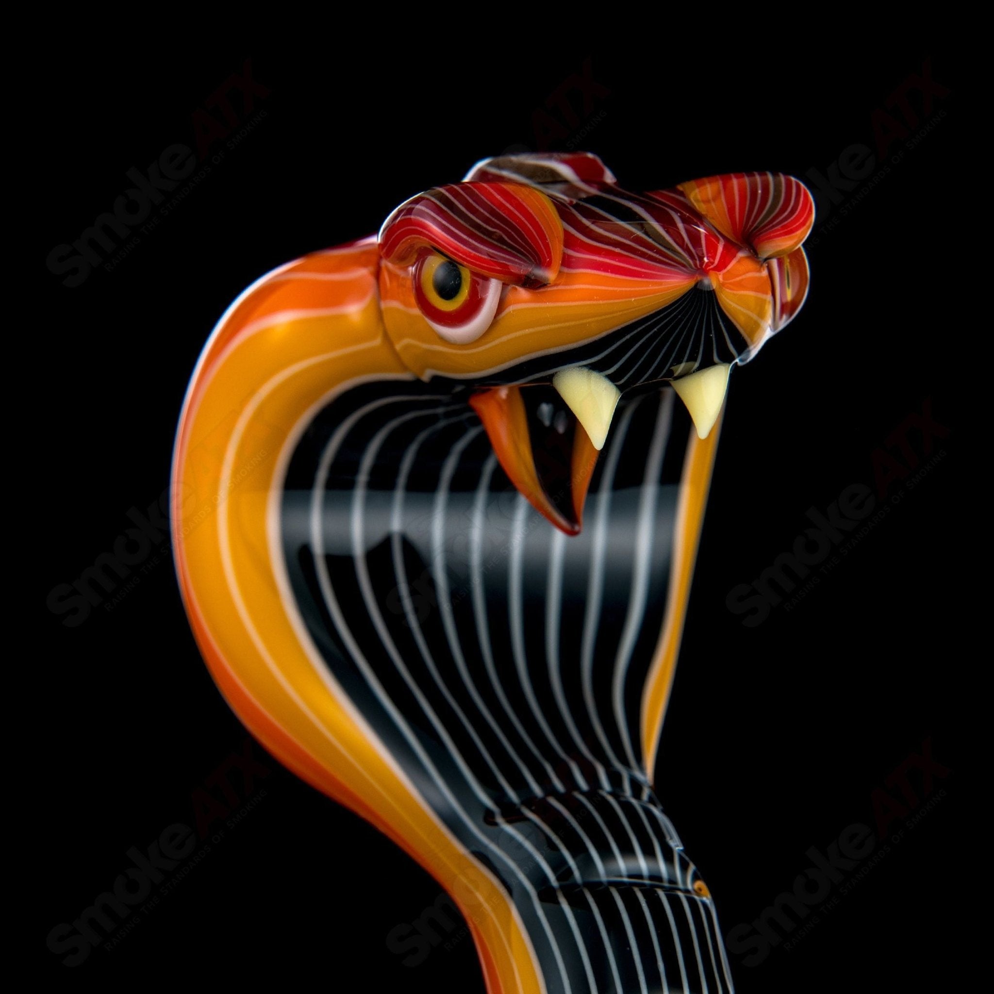 Heady glass concentrate rig featuring a King Cobra design by Niko Cray, with intricate glasswork and vibrant colors.