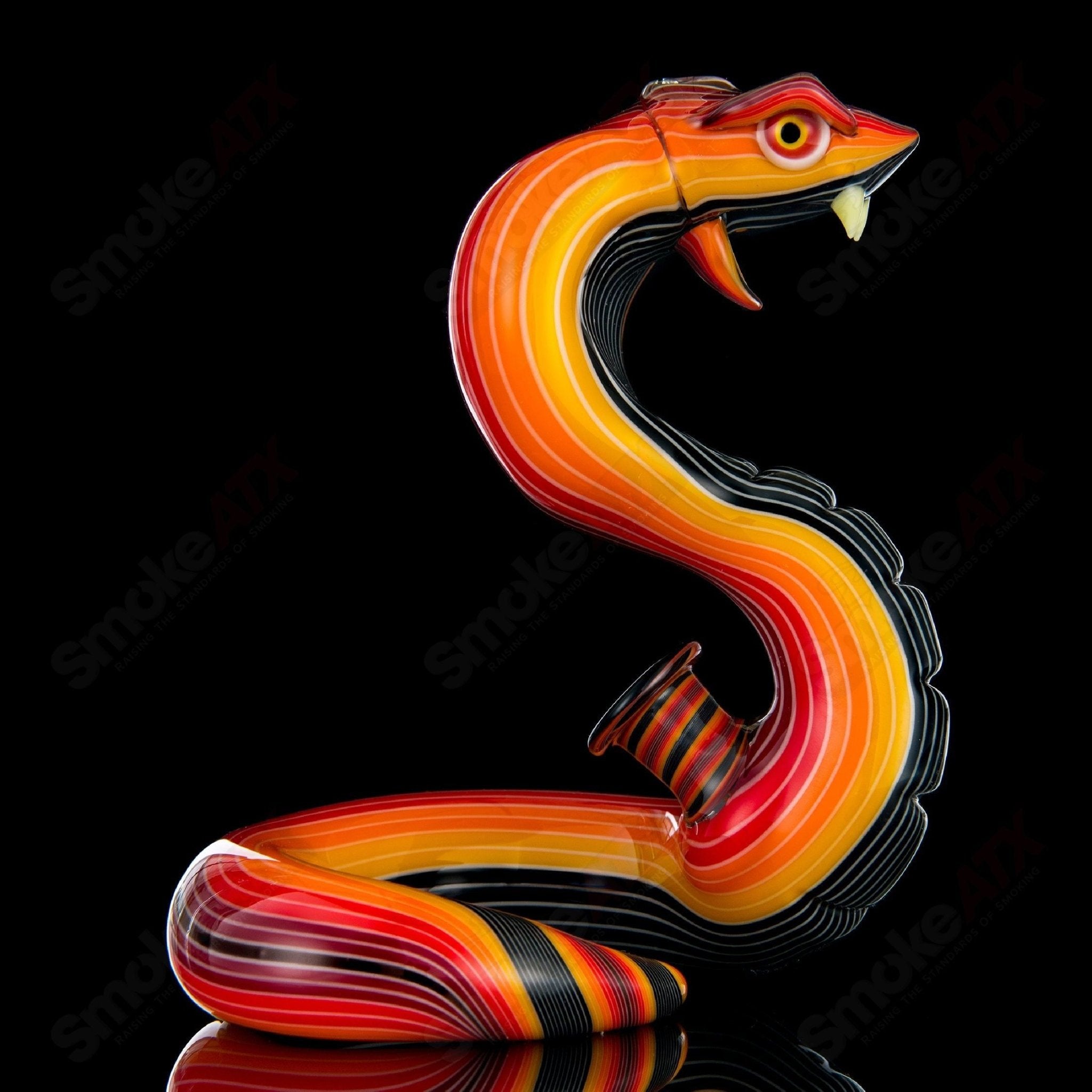 Heady glass King Cobra concentrate rig by Niko Cray featuring intricate design and vibrant glasswork.