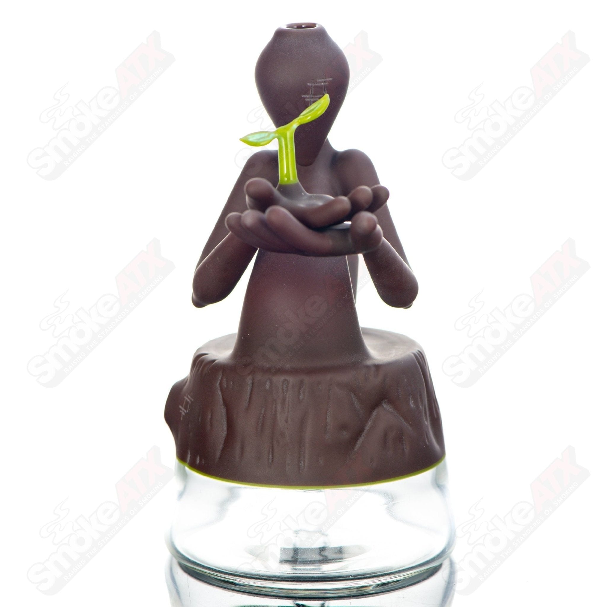 Yunk Glass Nurturing Nature Rig, a clear heady glass concentrate rig with intricate design details and a sturdy base.