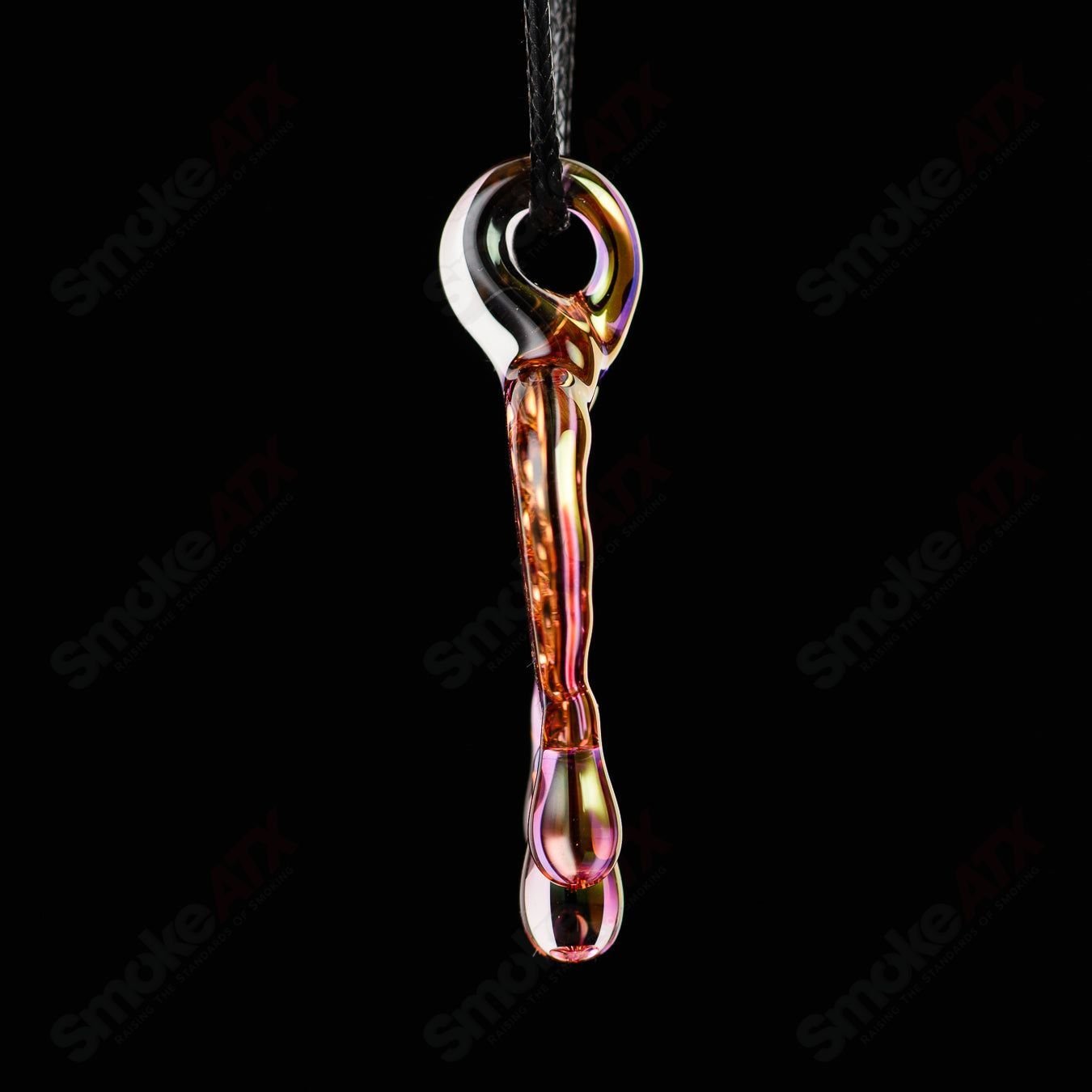 James Lang pressed honeycomb glass pendant hanging on a chain, showcasing intricate hexagonal design and warm amber tones.