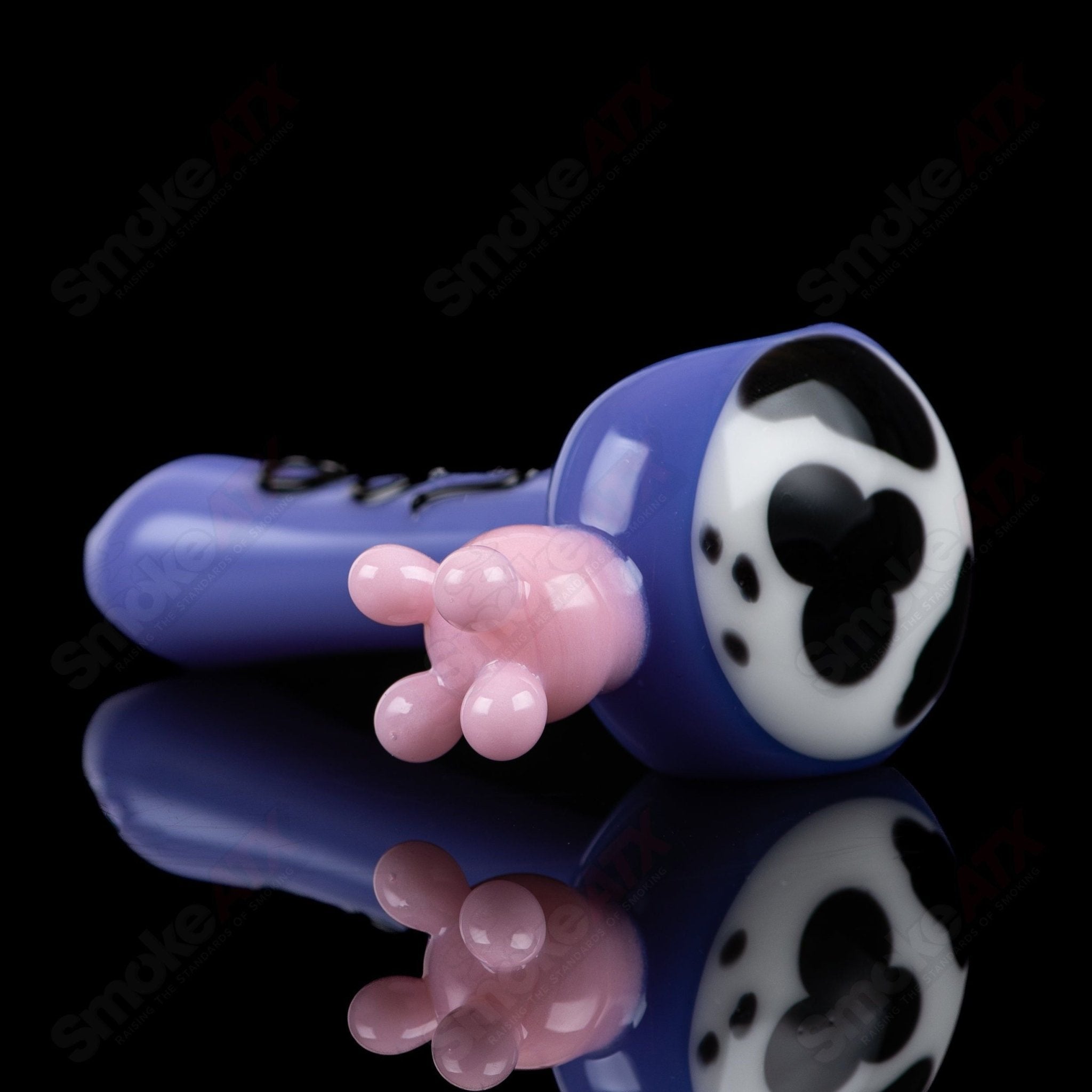 Purple cow print glass spoon pipe from Adventures In Glass Blowing, showcasing intricate glass-blown design and vibrant colors.
