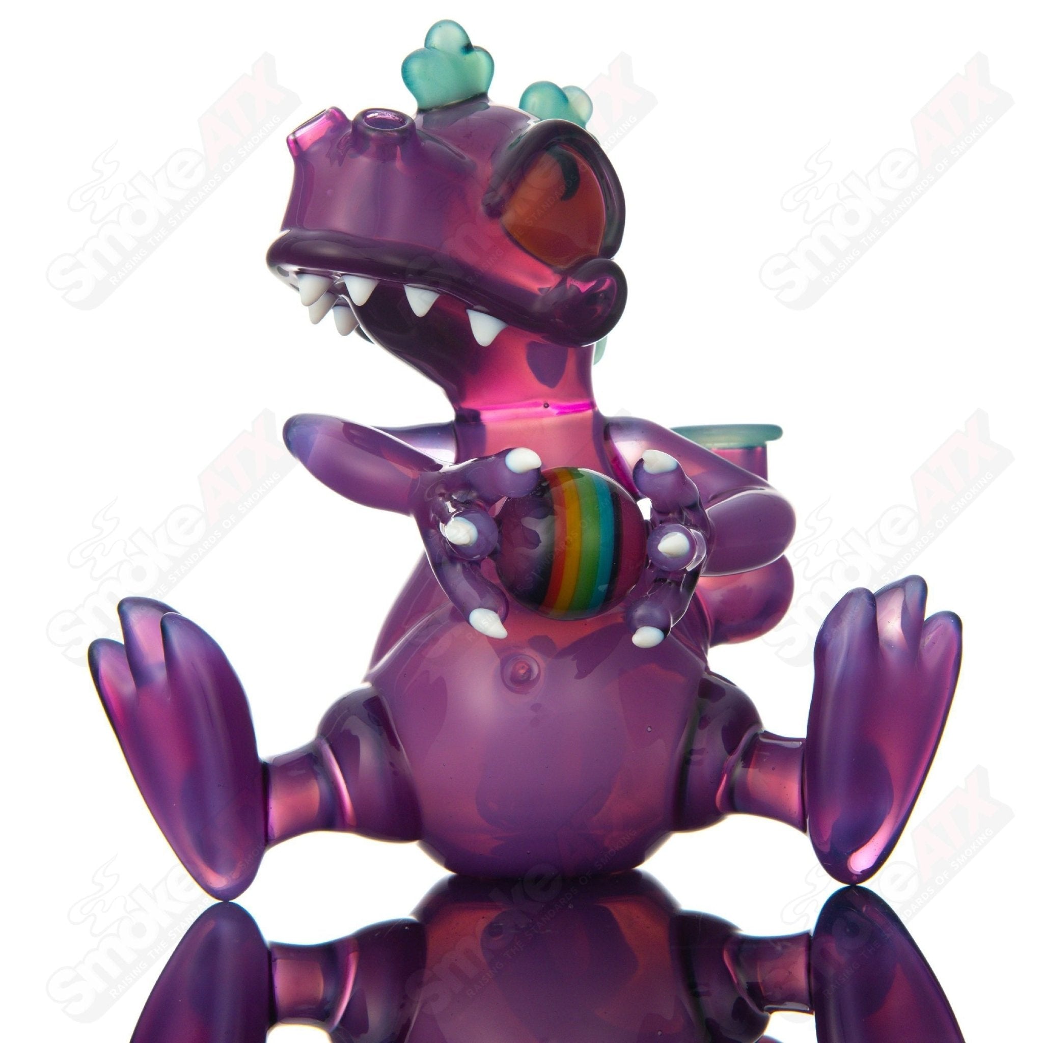 Purple Sitting Reptar concentrate rig with encalmo egg detail by J-Smart Glass, made of heady glass for dabbing.