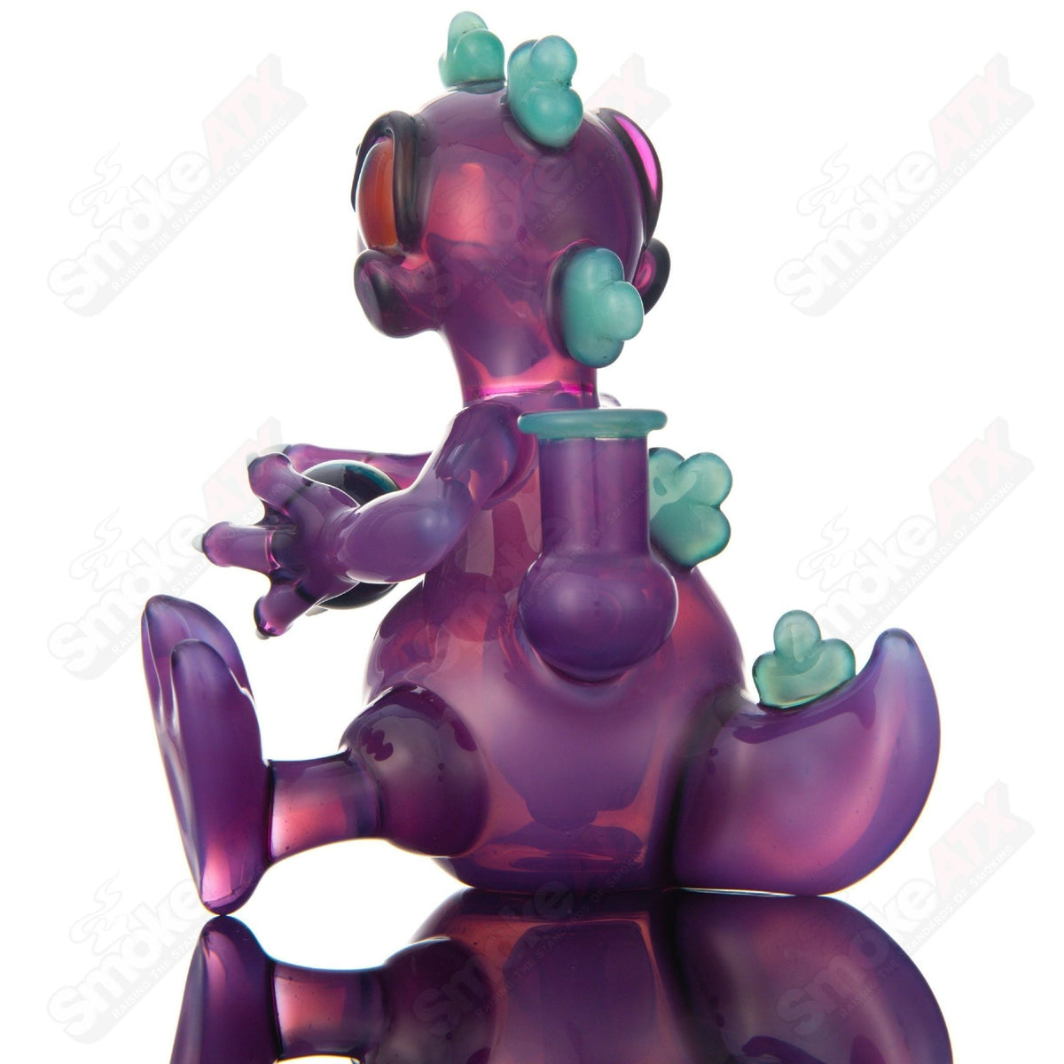 Purple Sitting Reptar concentrate rig with encalmo egg detail by J-Smart Glass, featuring a heady glass design and intricate craftsmanship.