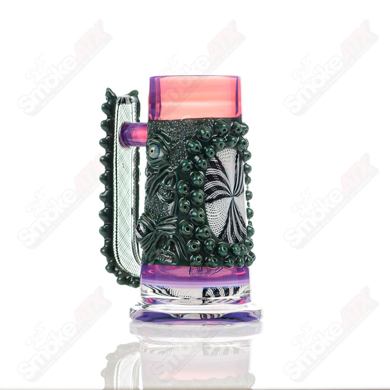 Reticello Many Face Drinking Mug by Salt Glass, handcrafted heady glass cup with intricate reticello design and multiple facial features.