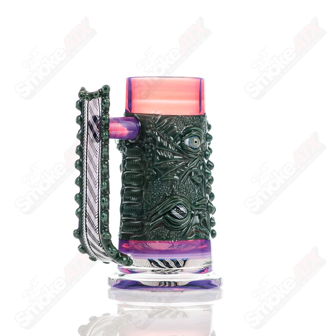 Reticello Many Face drinking mug by Salt Glass, a heady glass cup featuring intricate reticello glasswork and multiple face designs.