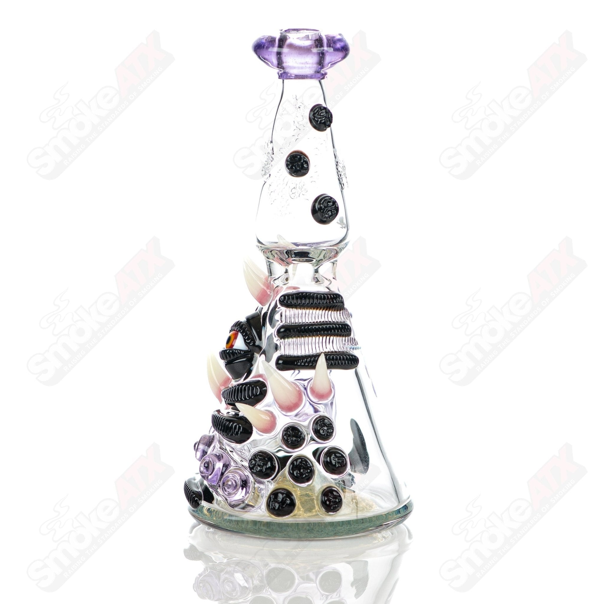 RipCurl by Helix & Salt Glass Heady Glass concentrate rig with intricate glass design and clear glass body.