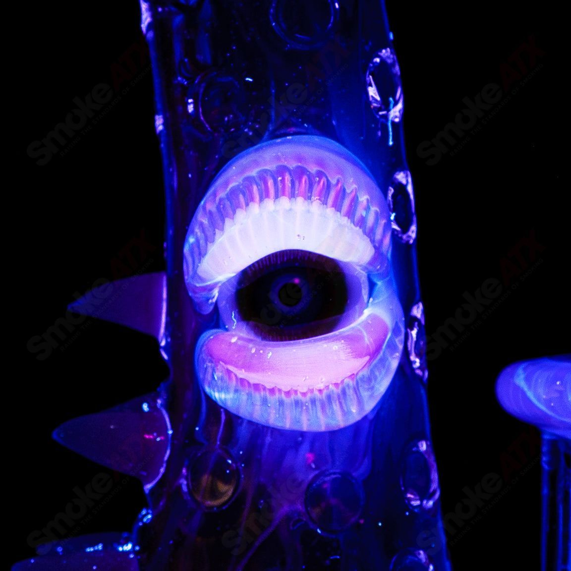 UV tie-dye Soul Flask glass by Salt Glass, a colorful concentrate rig featuring vibrant tie-dye patterns and a sleek heady glass design.