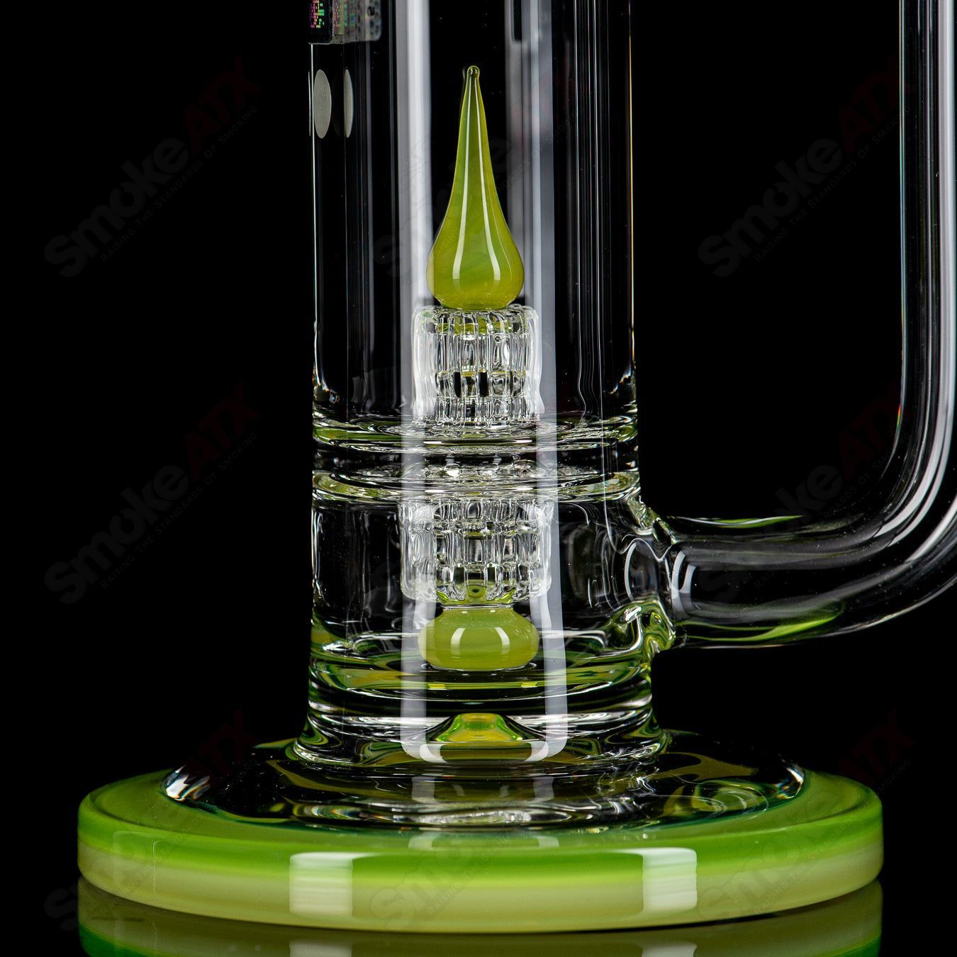 Glass waterpipe with tall stereo matrix design, Mobius brand, featuring intricate glasswork and a clear, cylindrical shape.