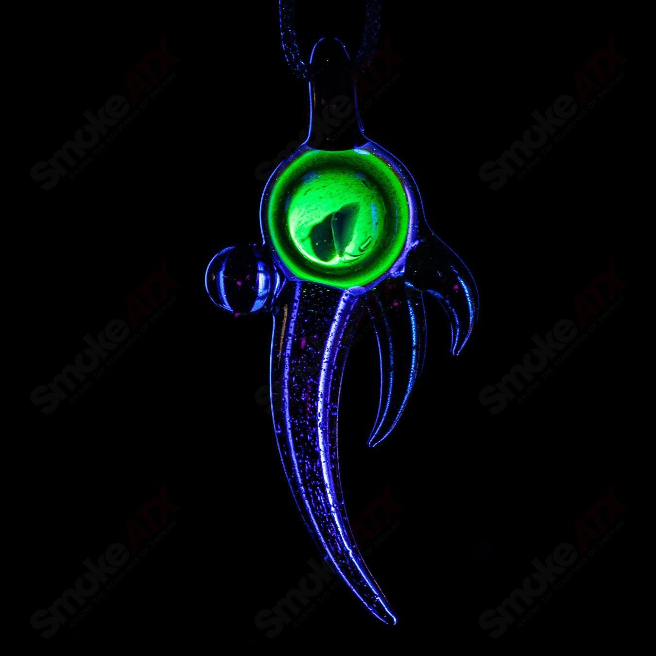 Dosh Glass amulet pendant featuring a colorful glass design, hanging from a black cord, on a neutral background.