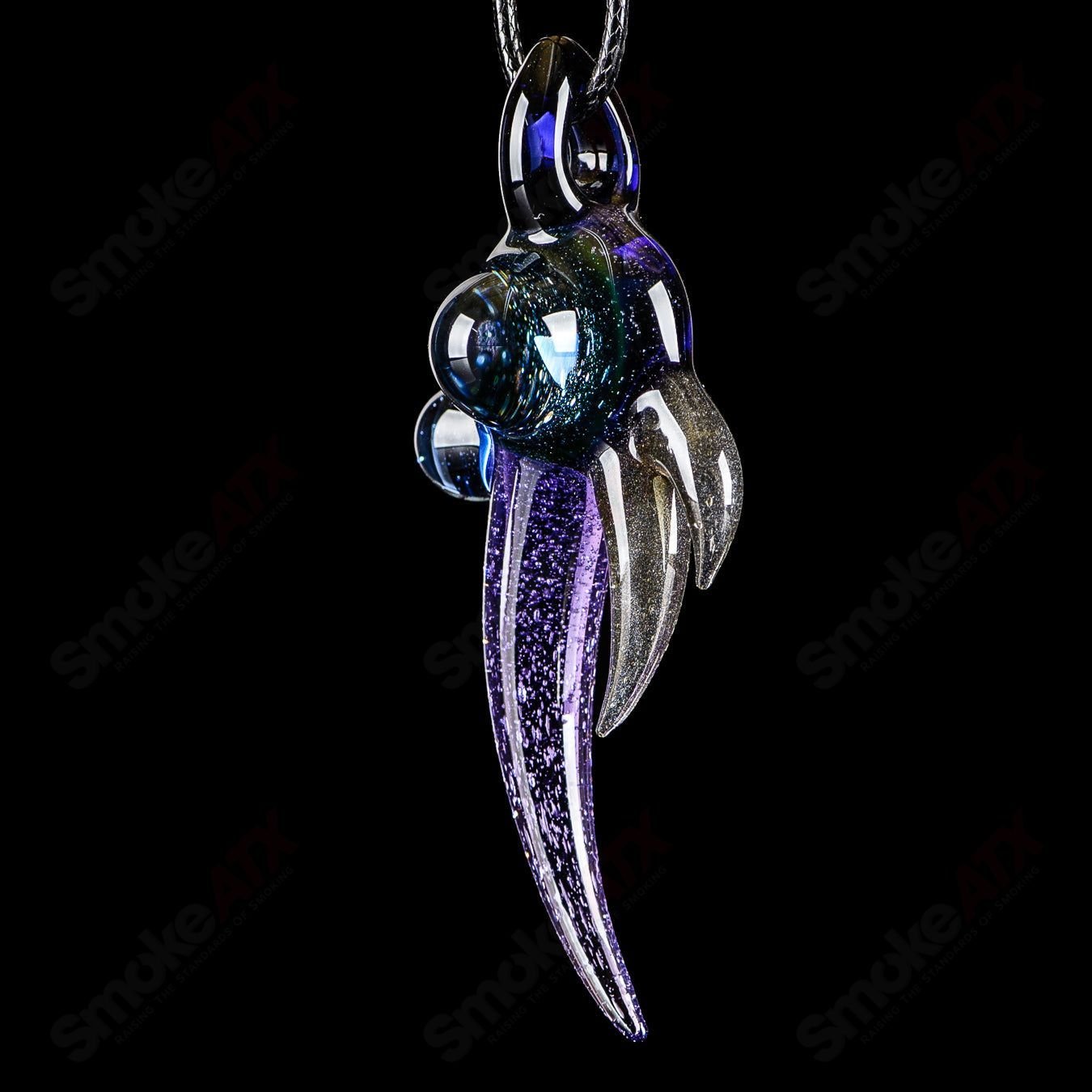 Dosh Glass amulet pendant made of clear glass with intricate design, hanging on a cord for a stylish accessory.