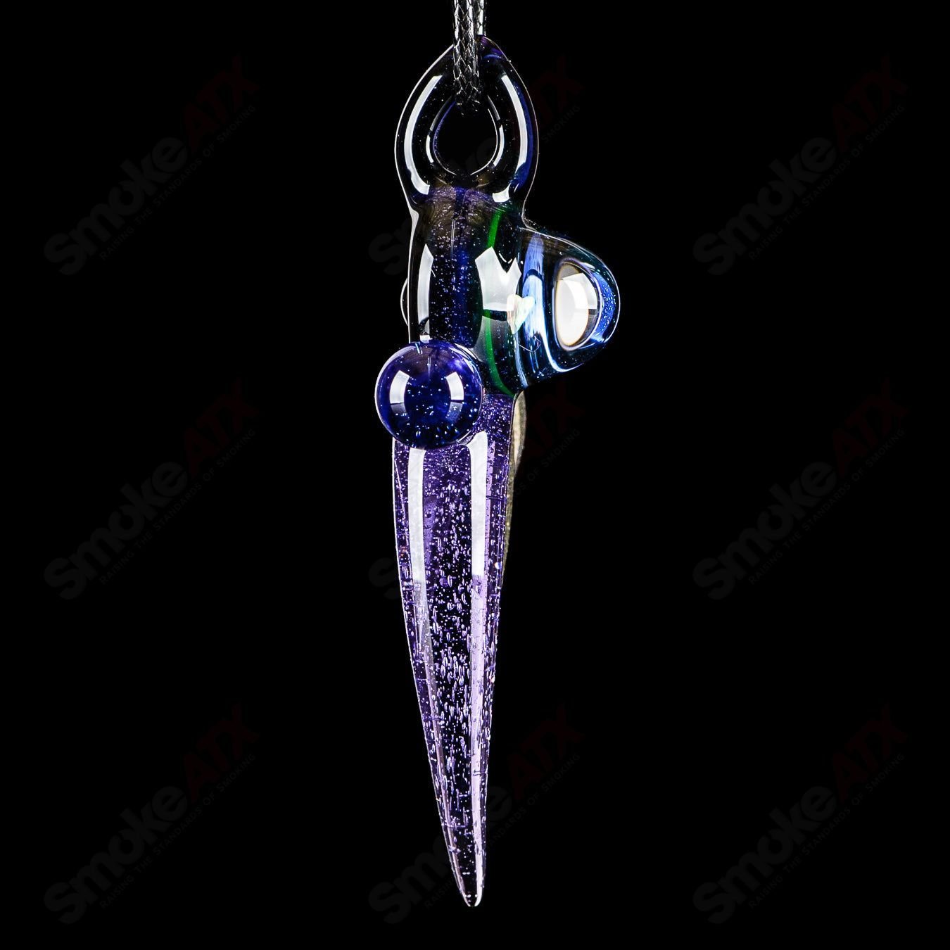 Dosh Glass amulet pendant made of clear glass, featuring a unique artistic design, hanging from a black cord.