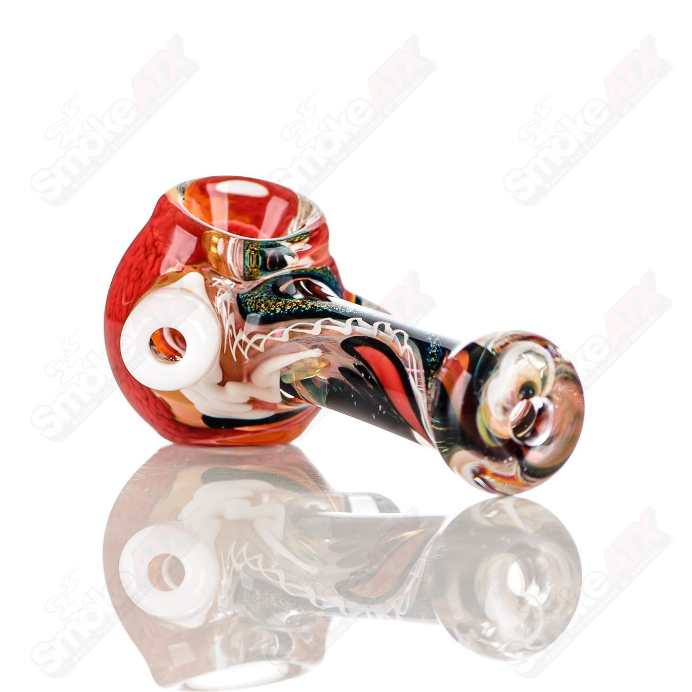 Color worked IO spoon pipe by Jeremy from Oregon, a hand-blown glass heady pipe with vibrant, artistic design.
