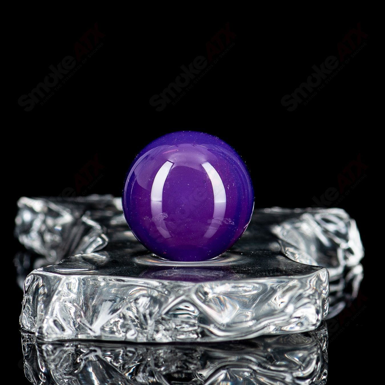 Glass marbles with a stacked top dot design by Indo Glass, featuring a clear round shape and colorful dot patterns