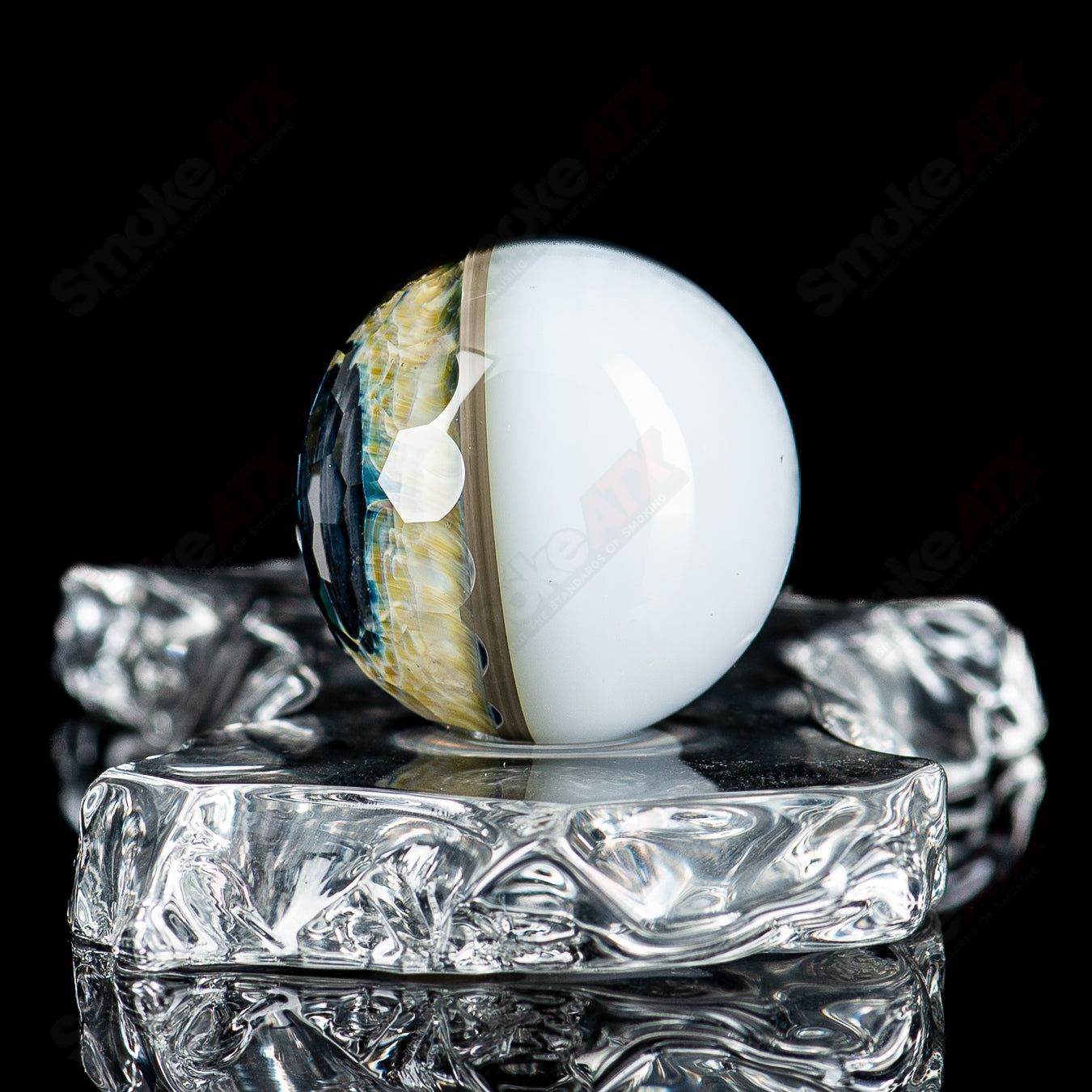 Faceted Eye Marble by Indo Glass, a handcrafted heady glass marble with intricate eye design and vibrant colors.