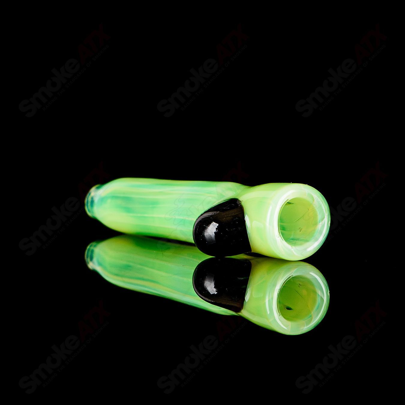 Glass chillum by JMK Glass featuring a signed I/O Worked design, with intricate glass artistry and a compact handheld shape.