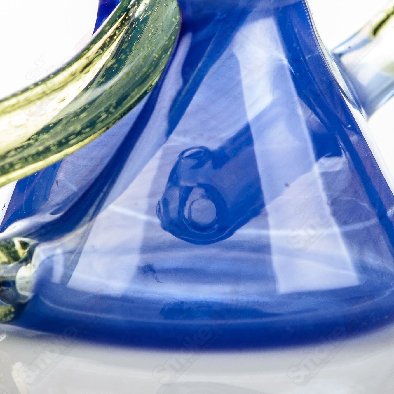 Captn Chronic Mini Two & Through CFL Recycler made of heady glass with intricate design and colorful accents.