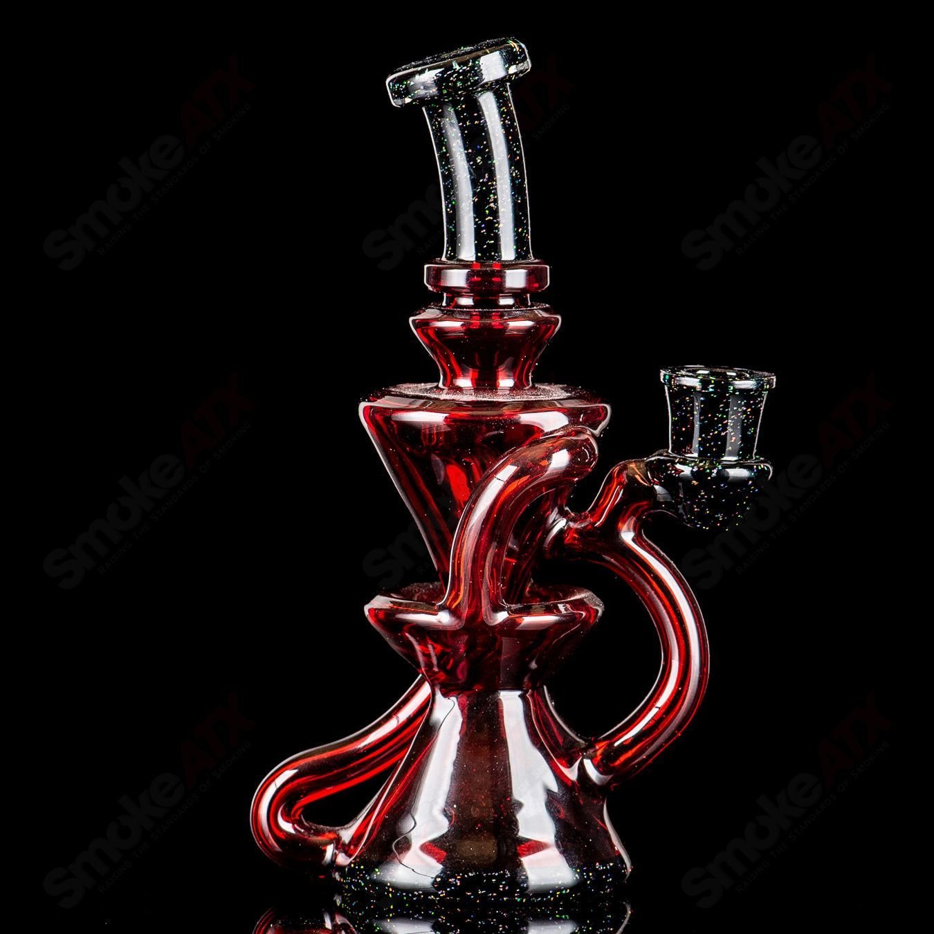 Captn Chronic Pomegranate and black crushed opal mini recycler concentrate rig, clear glass with colorful accents, detailed and artistic design.