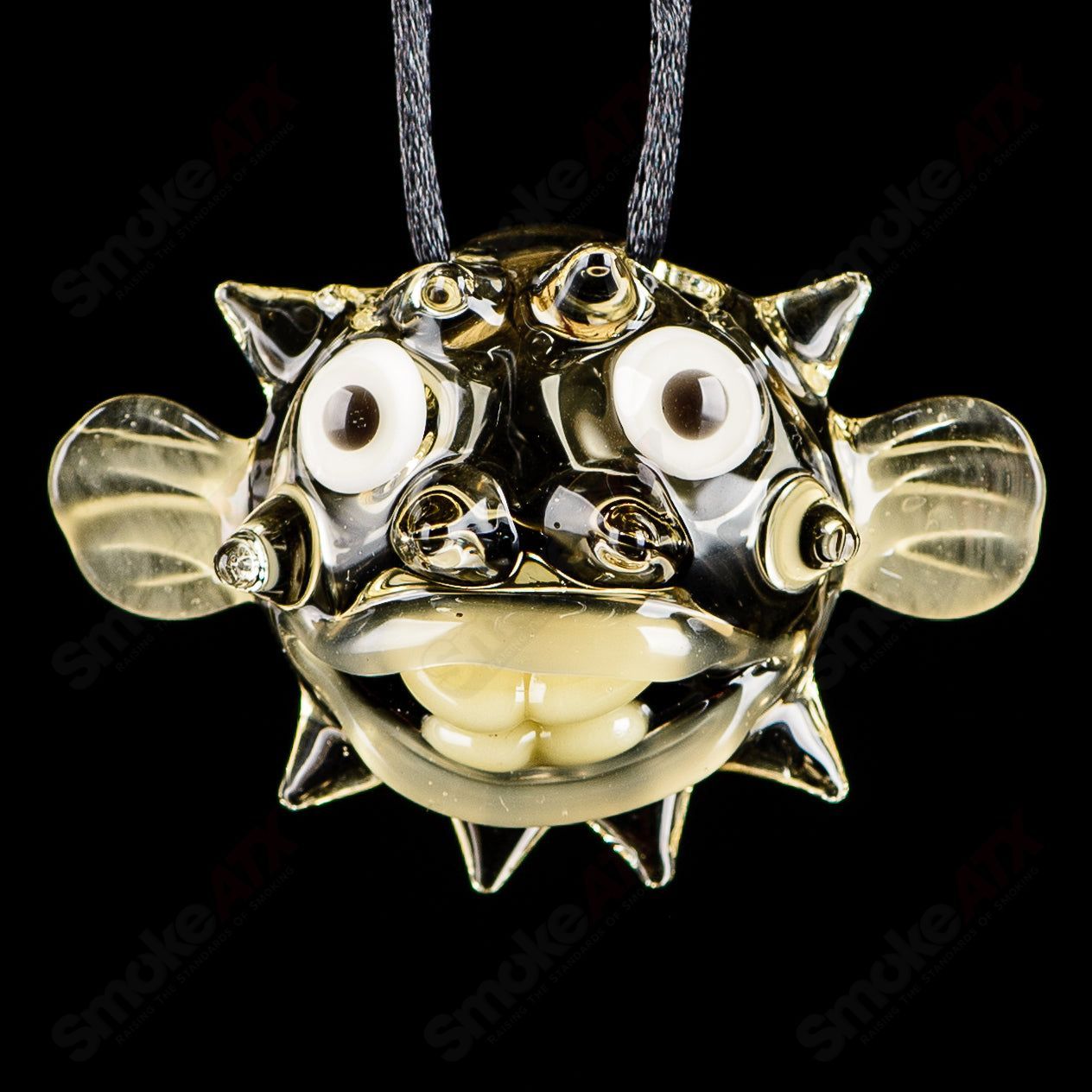 Chadd Lacy Glass puffer pendant made of colorful glass, featuring intricate designs and a rounded, puffed shape, ideal for jewelry.
