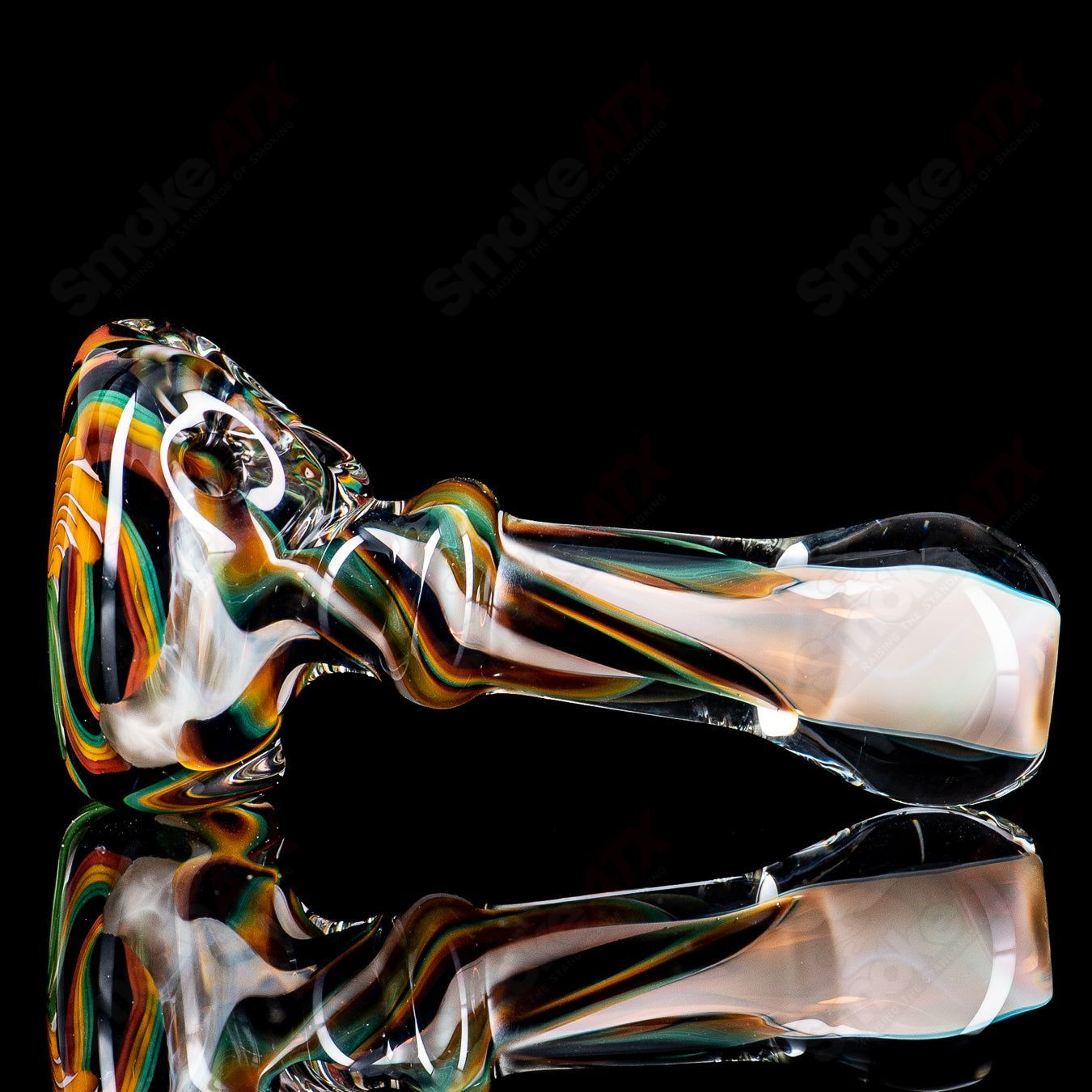 Clear glass pipe with a solid cane spoon design by Talent Glass Works, featuring intricate glasswork and a smooth mouthpiece.