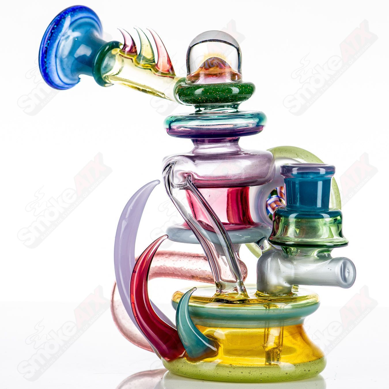 Freeek Glass Terpcycler Rig, a clear heady recycler glass piece with intricate design and recycling chamber for concentrates.