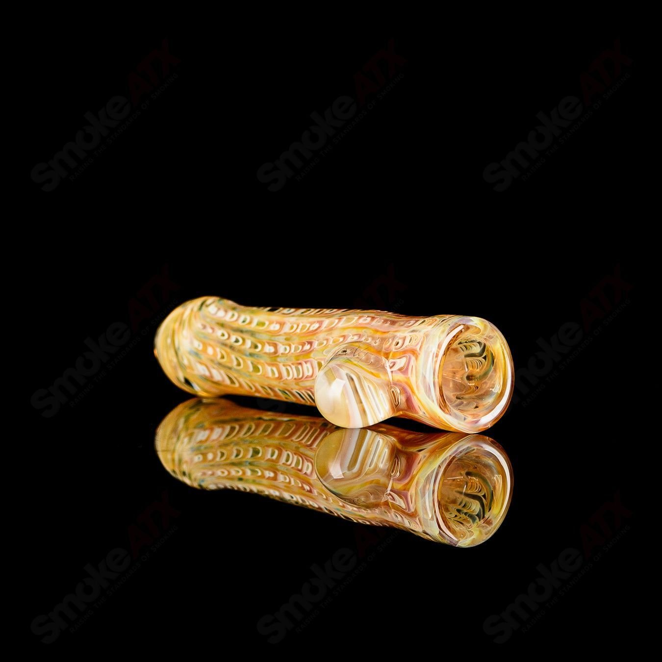 Transparent worked glass chillum with clear dot and JMK Glass signature, detailed design on the hand-held smoking pipe.