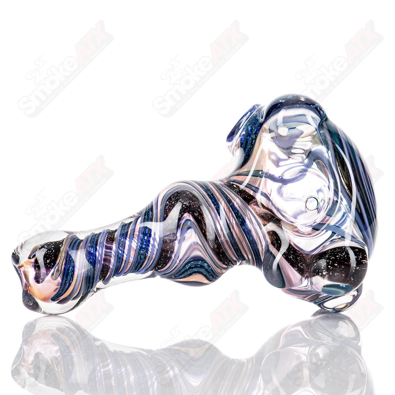 Molten Imagination #10 ISO Dichroic UV Spoon showing colorful, reflective glass with iridescent hues and a smooth, curved shape.