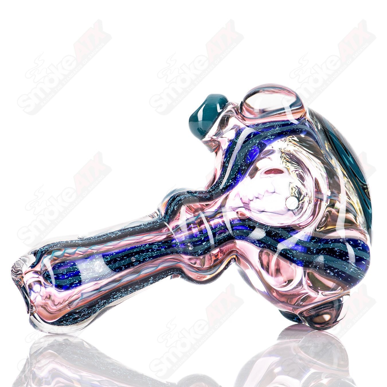 Molten Imagination #10 ISO Dichroic UV Spoon showing iridescent, colorful glass with a curved shape and reflective surface.