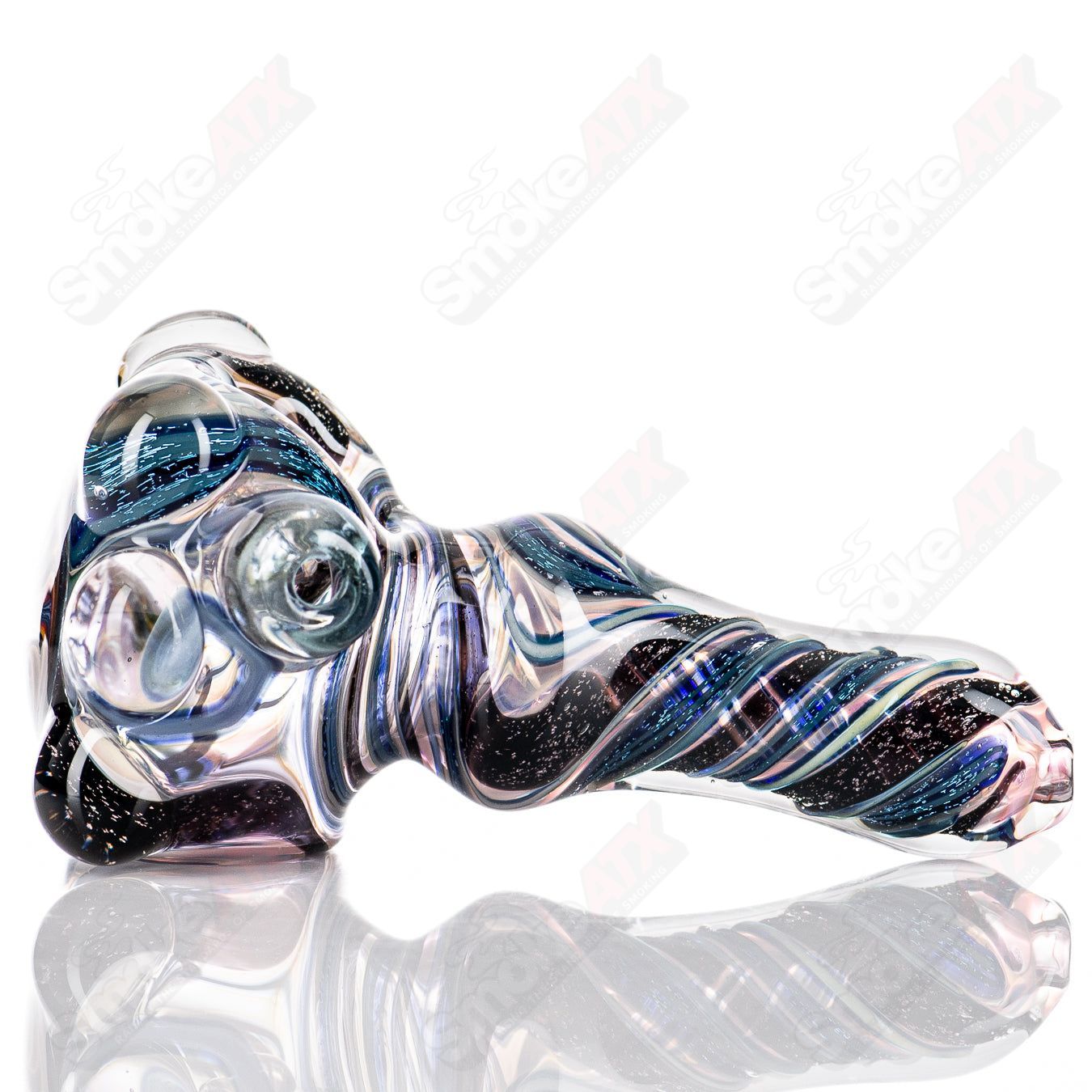 Molten Imagination #10 ISO Dichroic UV Spoon showing colorful, reflective glass with iridescent finish against a neutral background.