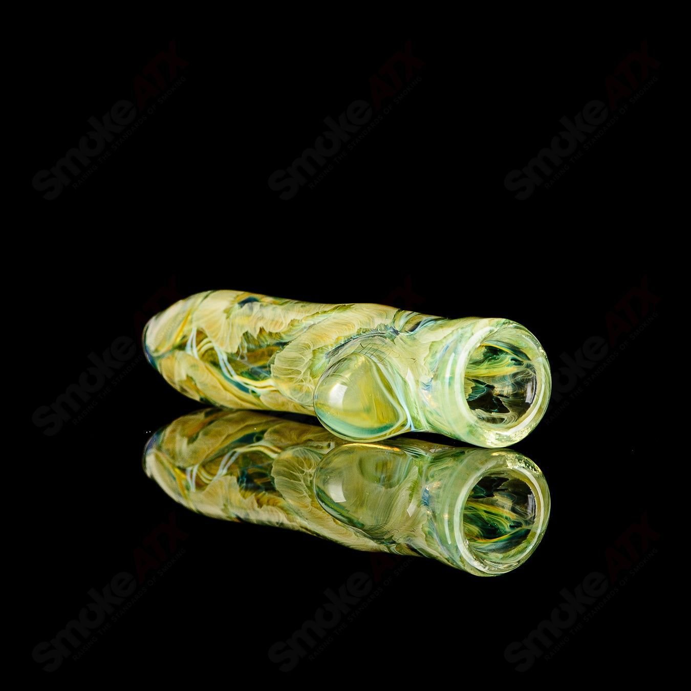 Glass chillum with hand-worked designs and signature from JMK Glass, featuring intricate patterns on clear glass.