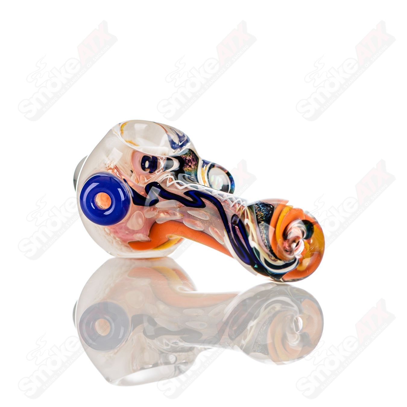 Colorfully worked IO spoon hand pipe by Jeremy from Oregon featuring vibrant 12-color design and smooth glass finish.