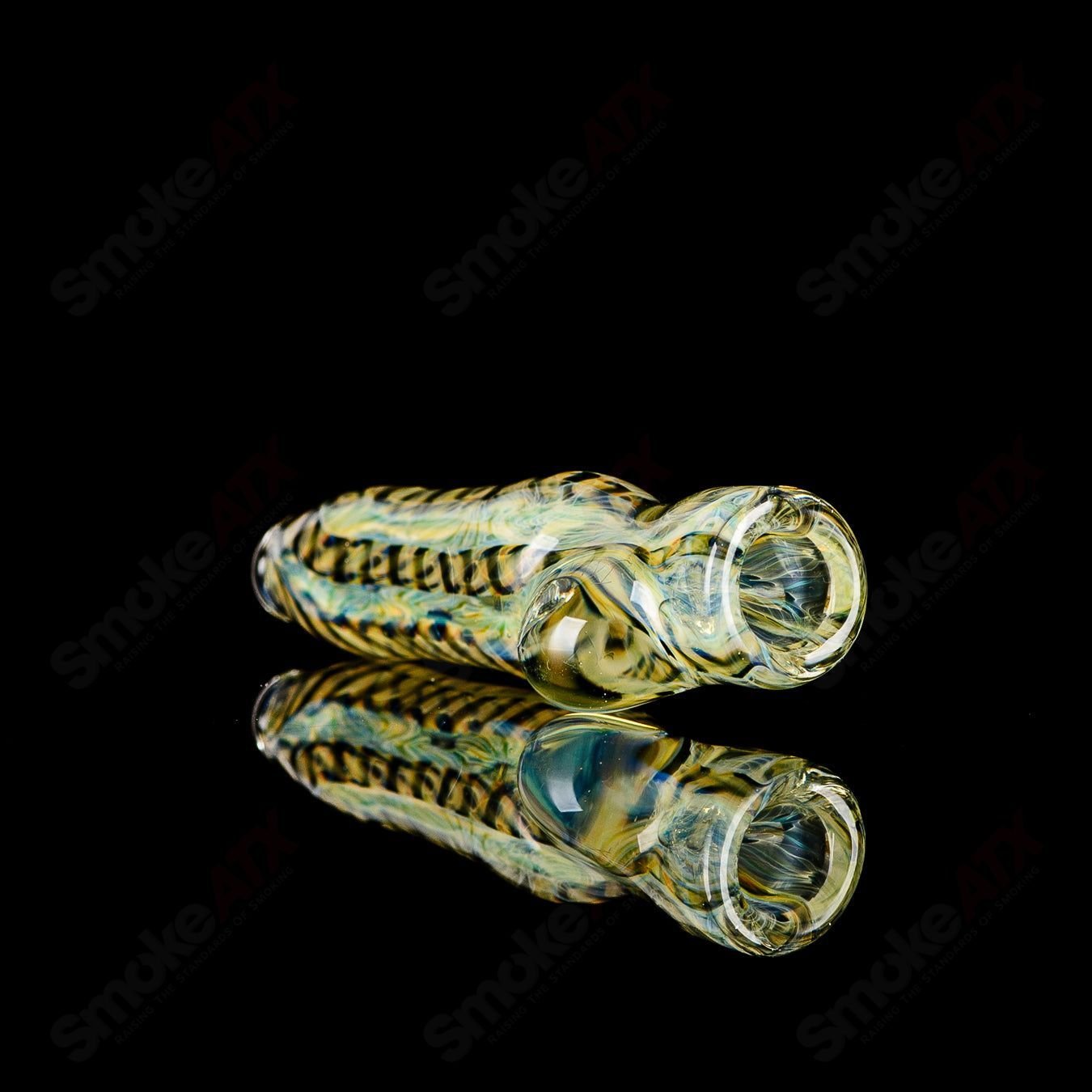 JMK Glass signed #12 I/O Worked Chillum, clear glass pipe with intricate worked design, artist signature visible.
