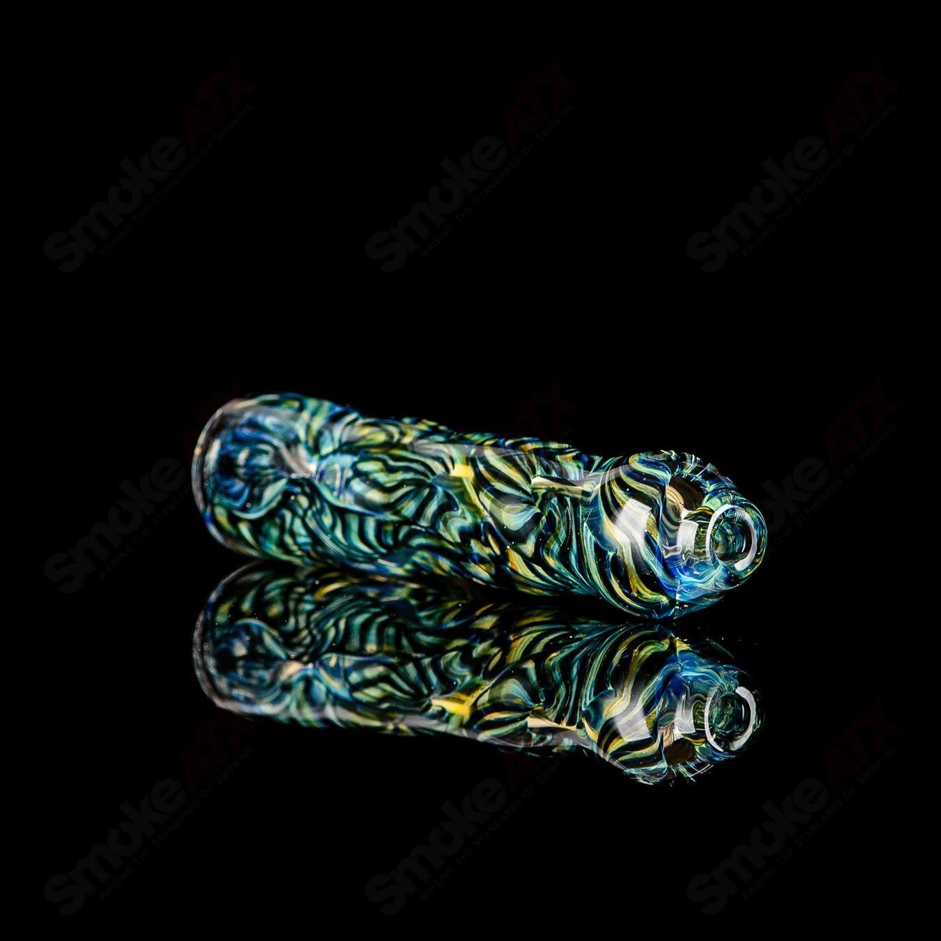 Handcrafted signed JMK Glass Chillum with intricate worked glass design, showcasing detailed craftsmanship and clear glass construction.