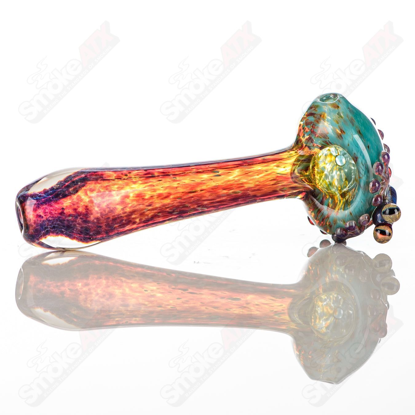 Beezy Glass Frog Spoon Pipe made of clear glass with green and yellow frog design, compact and smooth for easy handling.