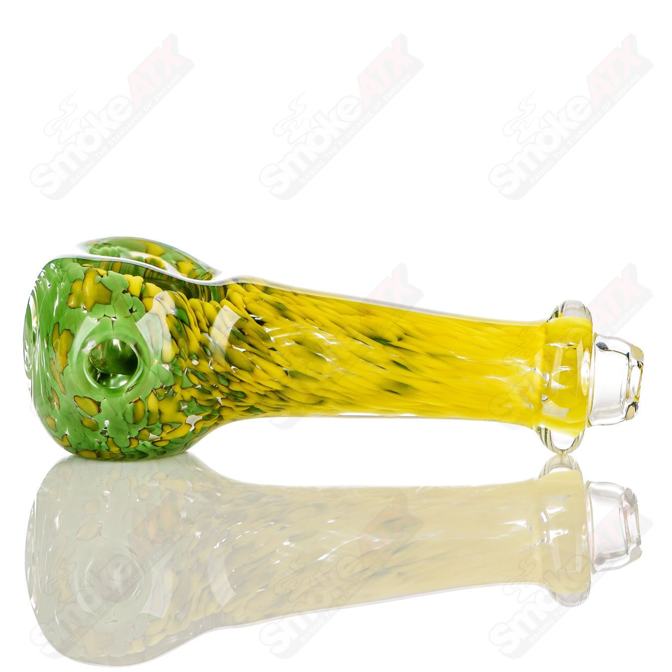 Green and yellow worked frit glass spoon pipe signed by JMK Glass, featuring intricate color patterns and craftsmanship.