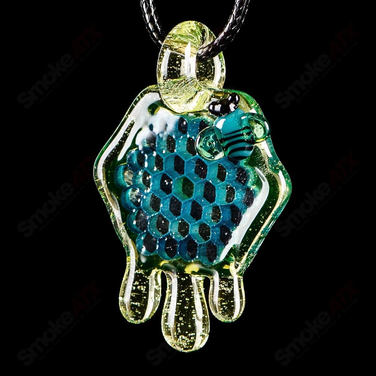 Joe P Glass 2-inch honeycomb drip pendant in teal, UV green, and yellow, featuring vibrant heady glass pendant design.