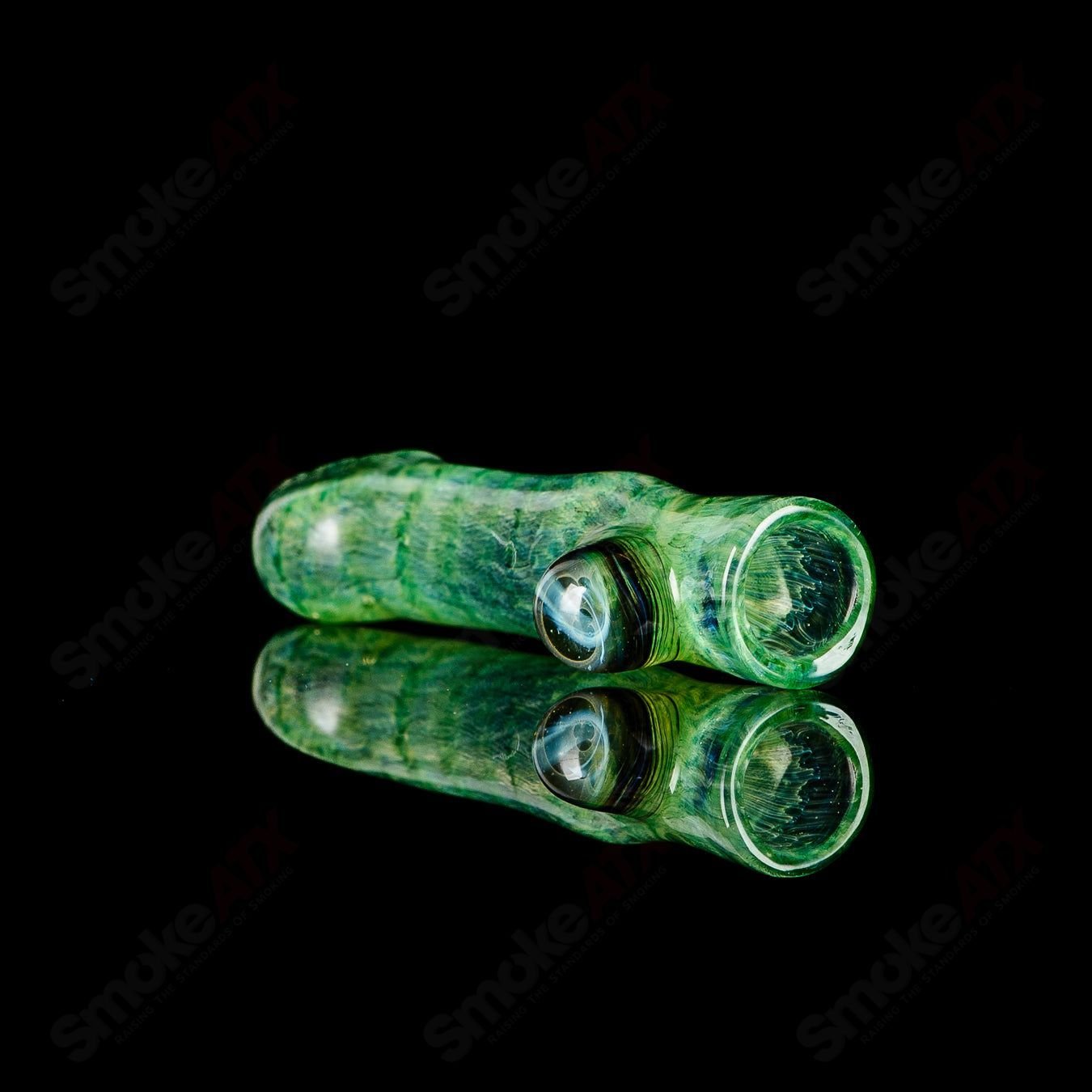 JMK Glass signed I/O Worked Chillum made of clear glass with intricate worked design, showcasing craftsmanship.