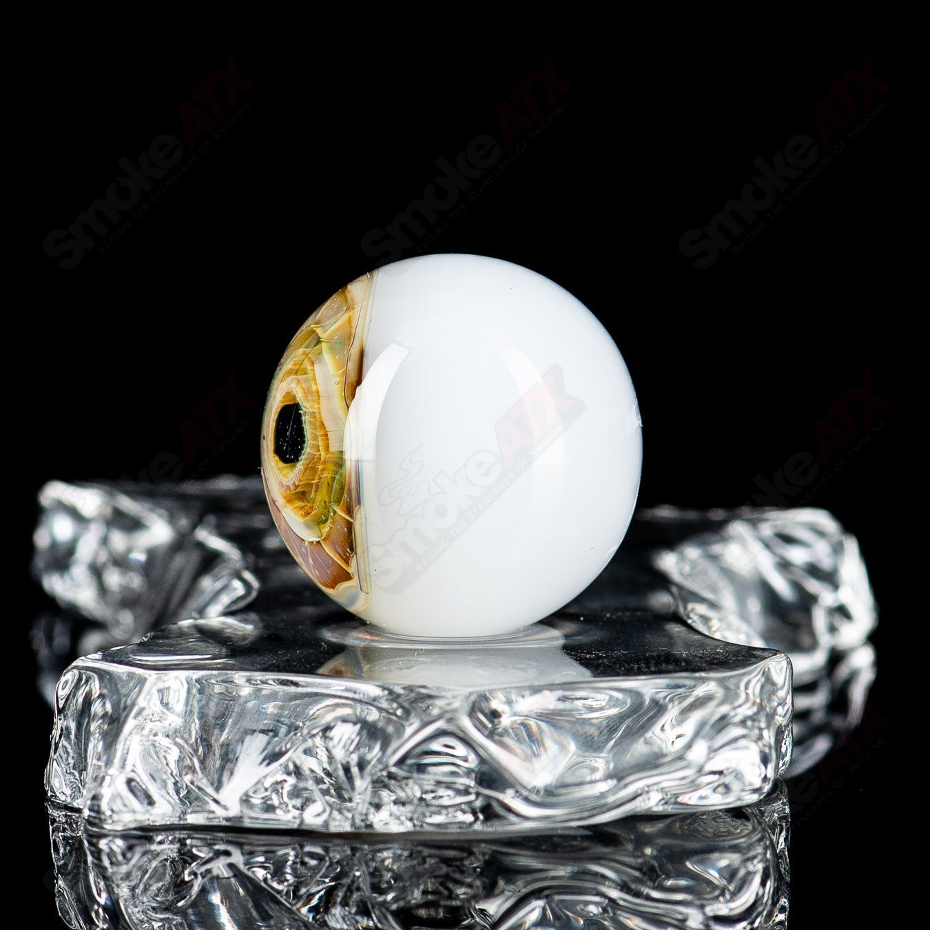 Colorful Indo Glass Skull Eye Mili Top heady glass pipe with intricate marbles and detailed skull and eye designs.