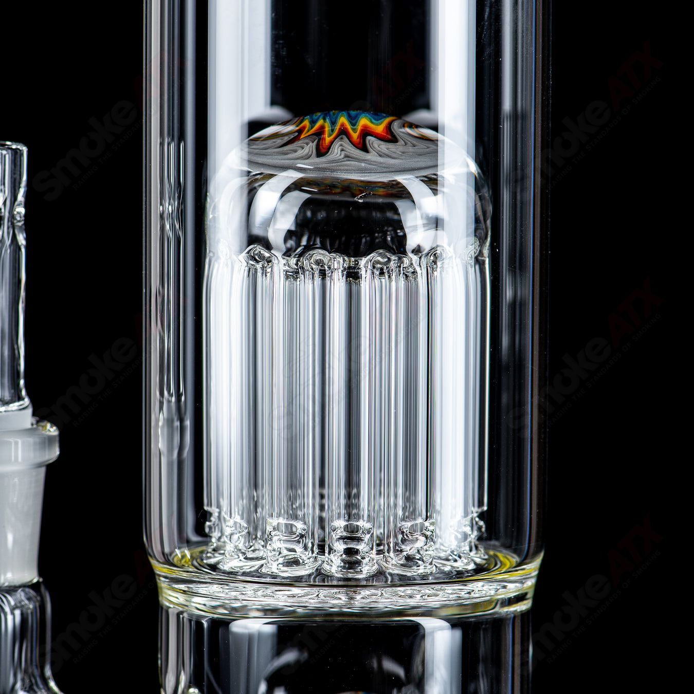 Toro glass straight tube with 18mm 7/13 arm percolator and reversal caps, featuring clear glass and intricate design details.