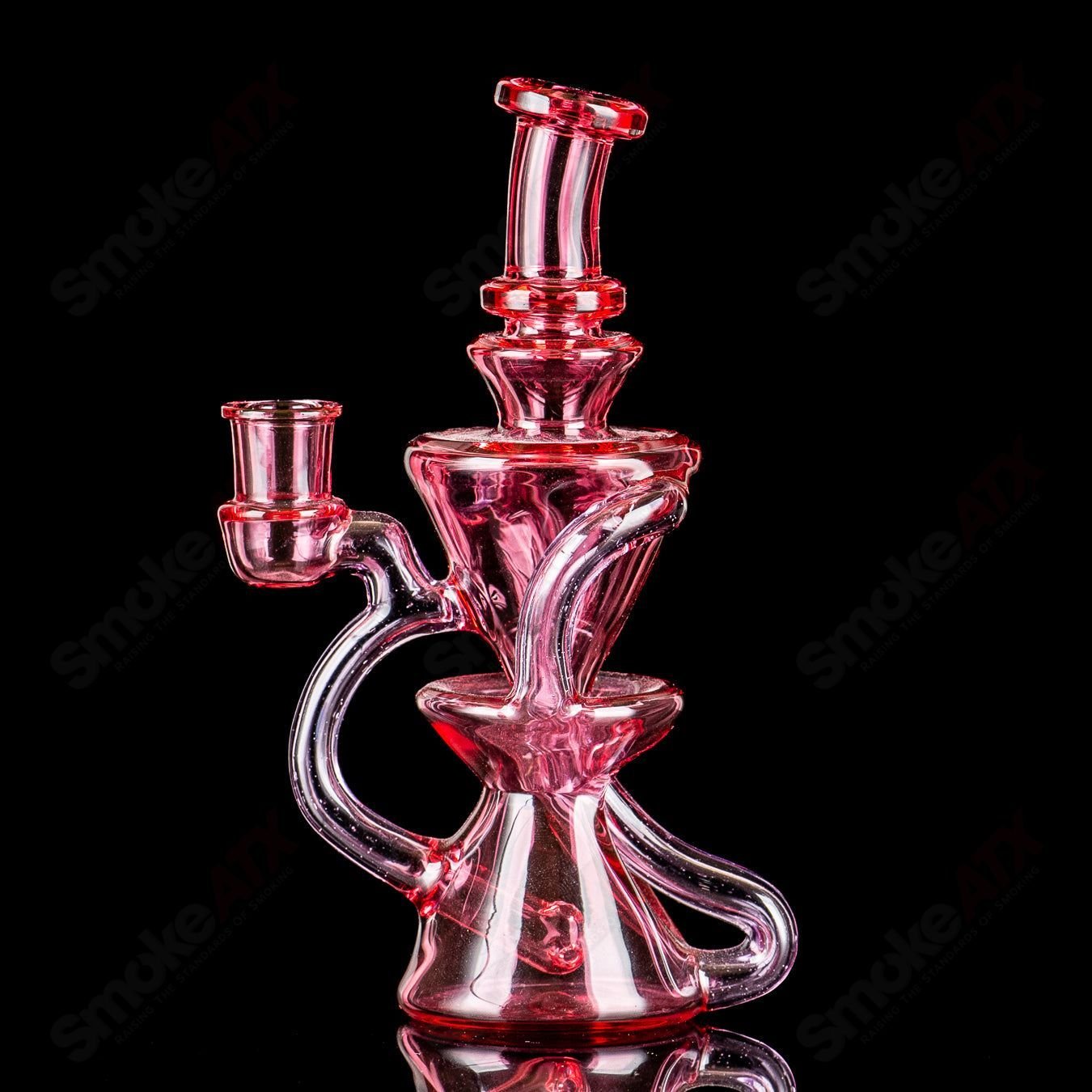 Mini recycler glass pipe by Captn Chronic, featuring a compact heady design with intricate glass details for smooth smoking.