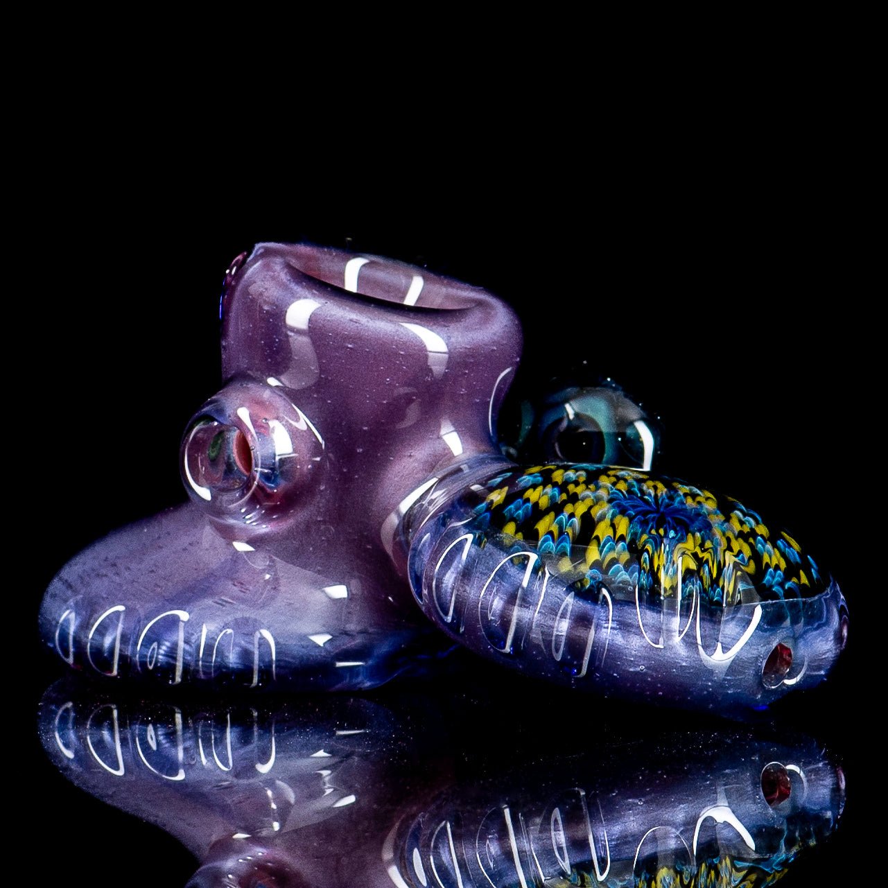 Hand pipe by Rotational Science featuring a Dottacello design with three pockets, made of colorful heady glass.