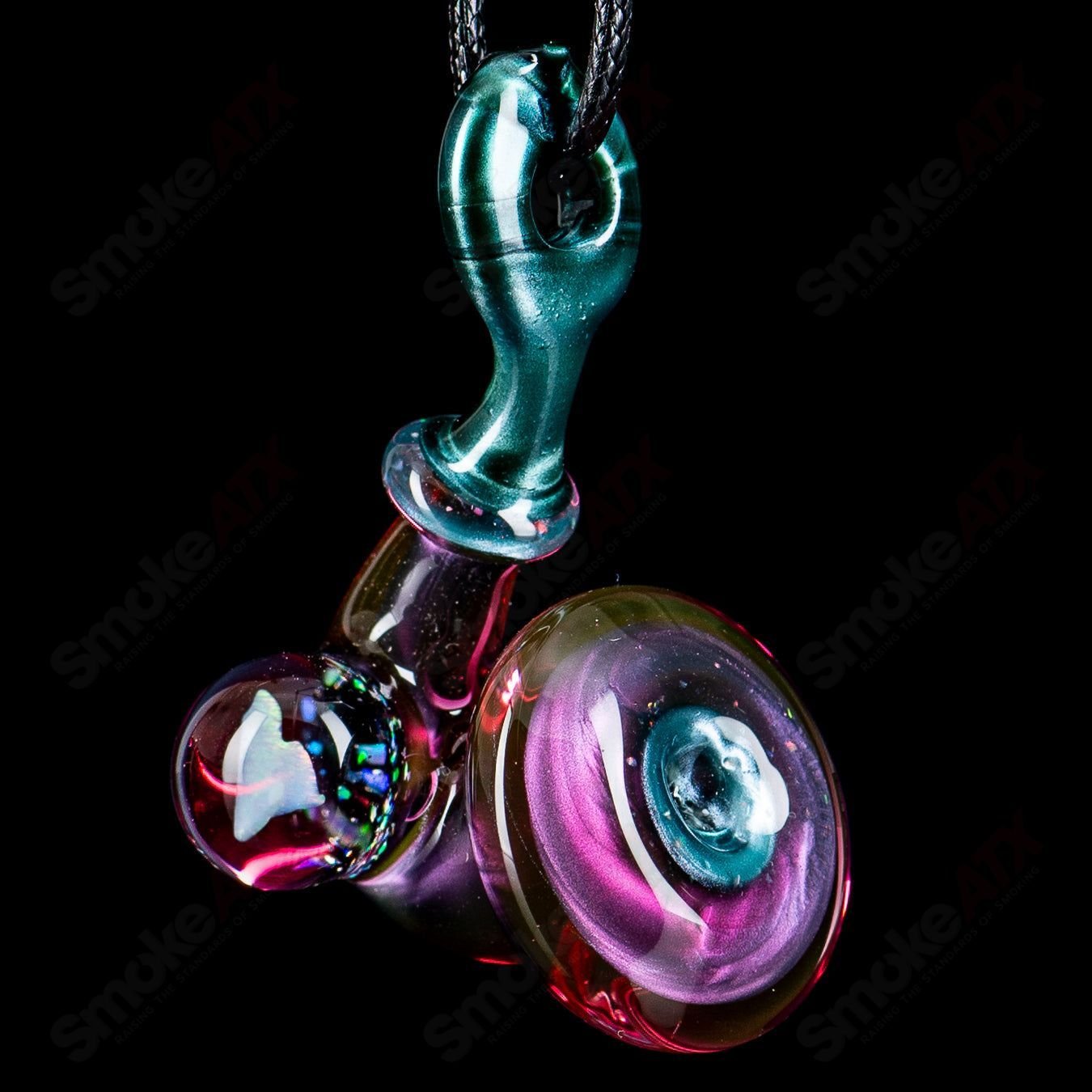 Sherlock Pendant by JMass featuring a heart-shaped opal embedded in a glass pendant with intricate heady glass design.