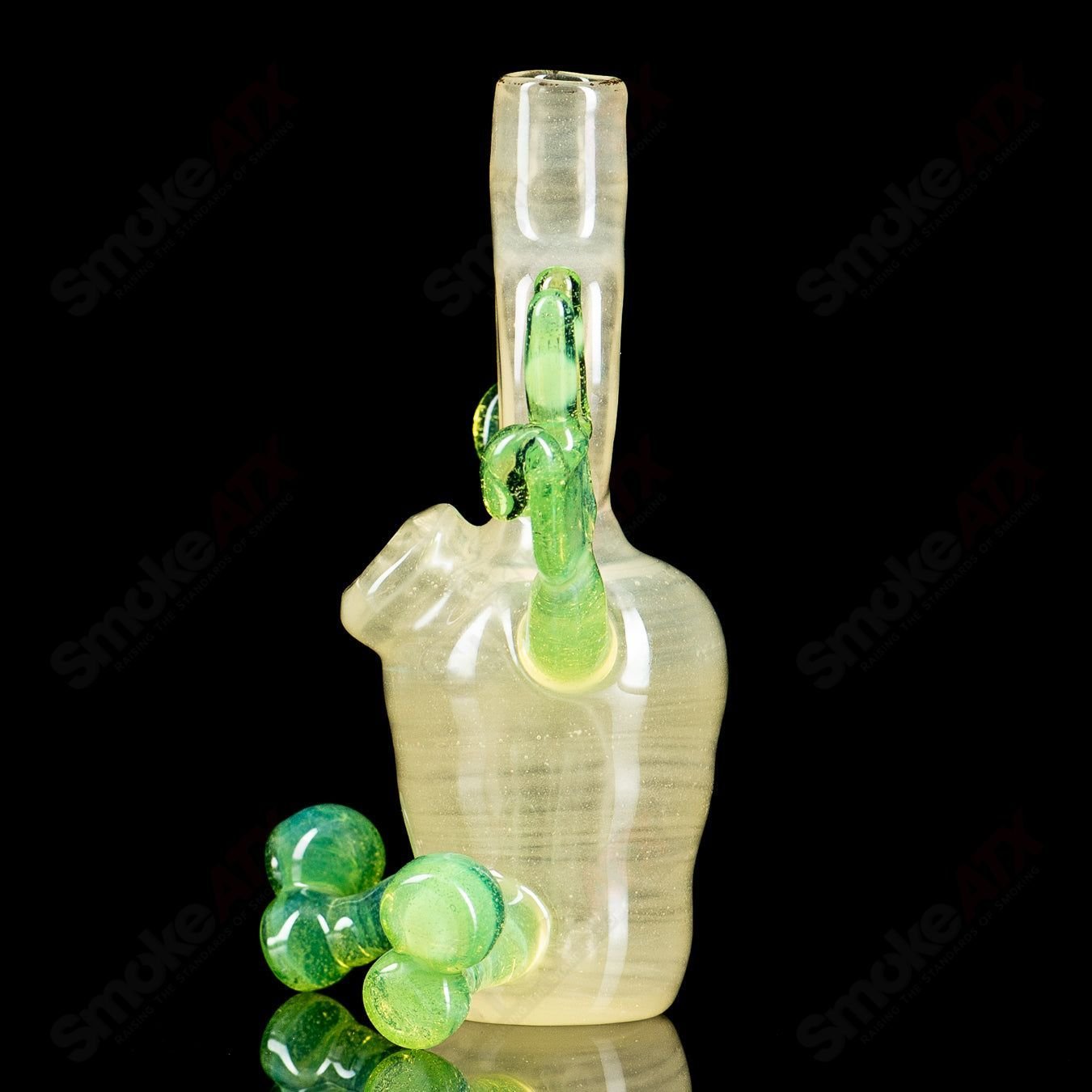Glass waterpipe rig with three sitting chambers by MJ Meltz, featuring clear glass design and intricate detailing.