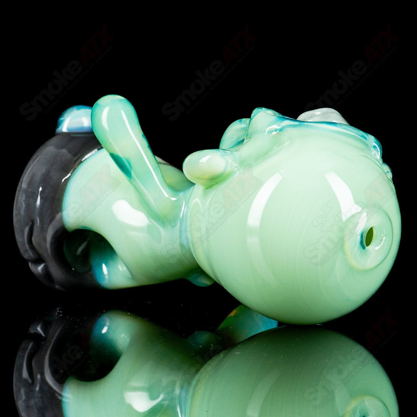 Hand pipe shaped like a zombie hand by Ghost, made of heady glass, featuring detailed zombie finger and bone design.