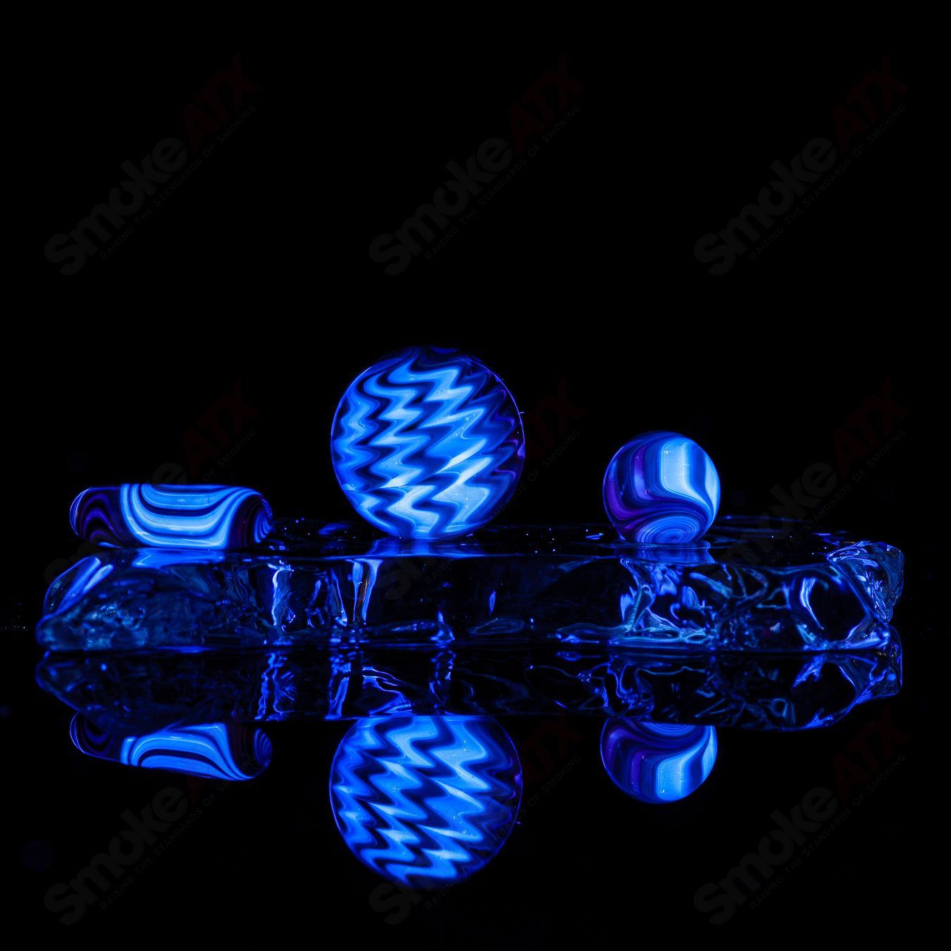 Set of three Indo Glass UV color worked slurpers in pomegranate, tan, and lava for glass accessories.