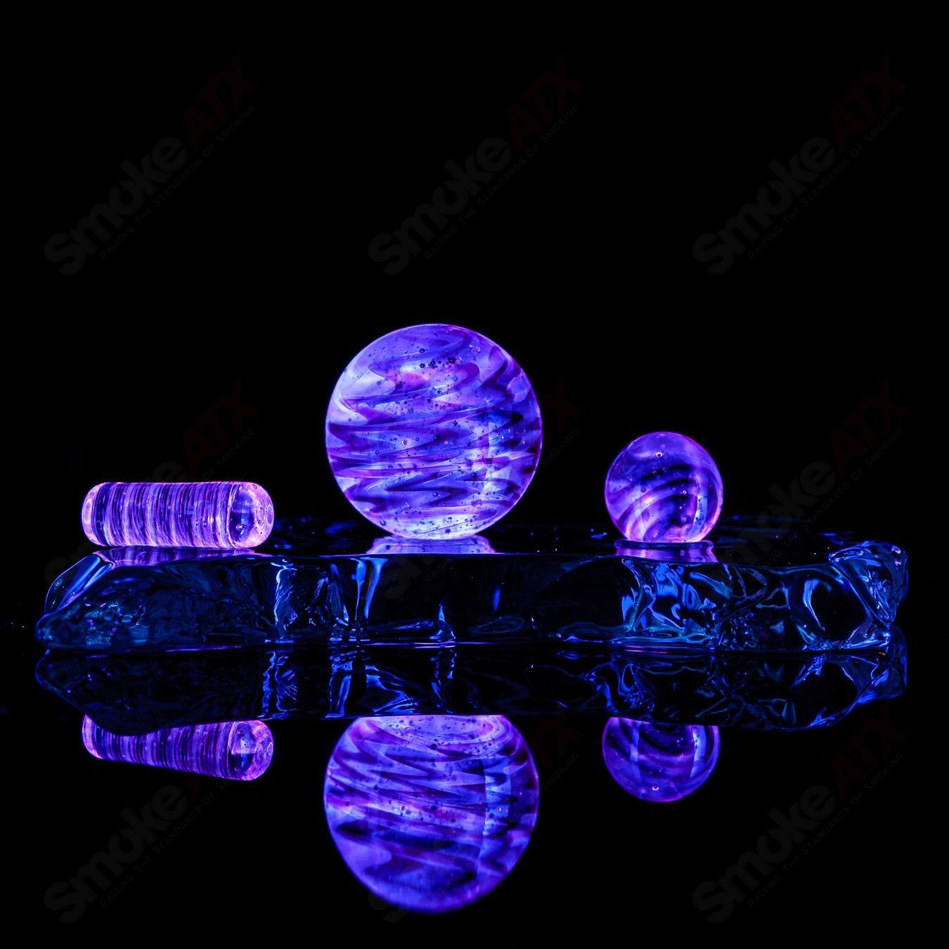 Three-piece UV Glow Slurper Set by Indo Glass with gold ruby and blue lava designs, made of glass accessories for smoking.