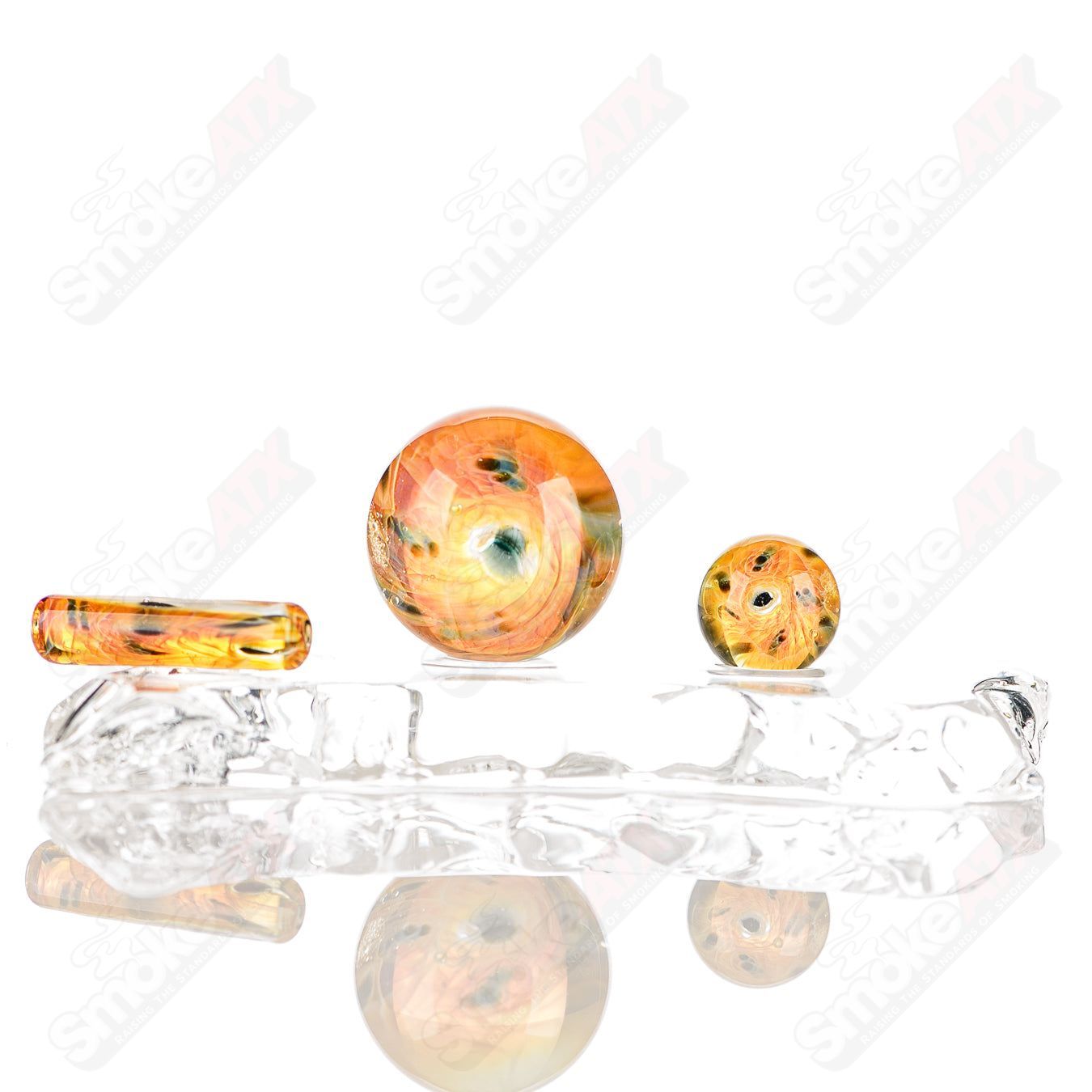 Three-piece UV Eye Cluster Milli Slurper set by Indo Glass, colorful glass accessories for smoking rituals.