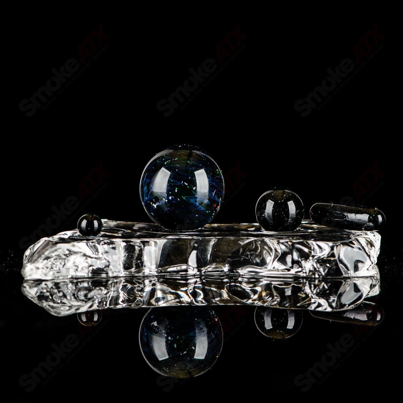 Four-piece UV Black Magic slurper set by Indo Glass featuring galaxy, citrine, and Lucy designs on clear glass accessories.